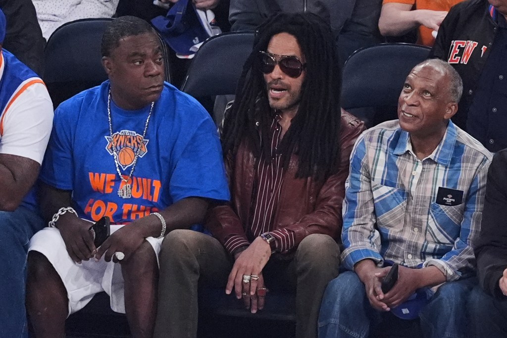 Lenny Kravitz, center, and Tracy Morgan, left, watch during the first half of Game 6 in the Eastern Conference semifinals of the NBA basketball playoffs between the New York Knicks and the Boston Celtics