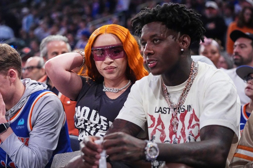 Ice Spice, left, and New York Jets' Sauce Gardner watch during the first half of Game 6 in the Eastern Conference semifinals of the NBA basketball playoffs between the New York Knicks and the Boston Celtics