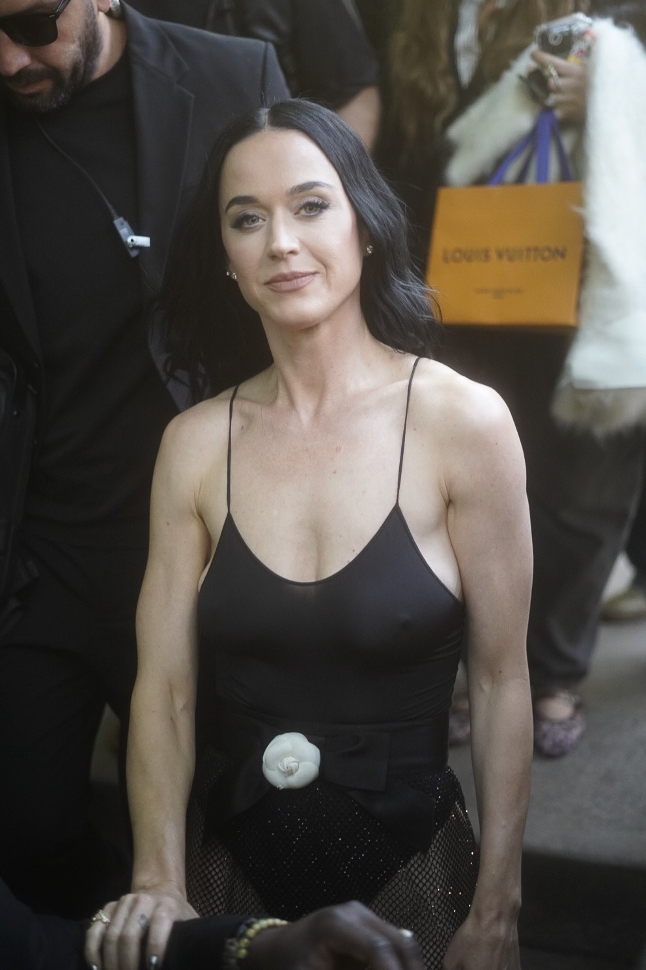 Katy Perry smiles in a black outfit. 