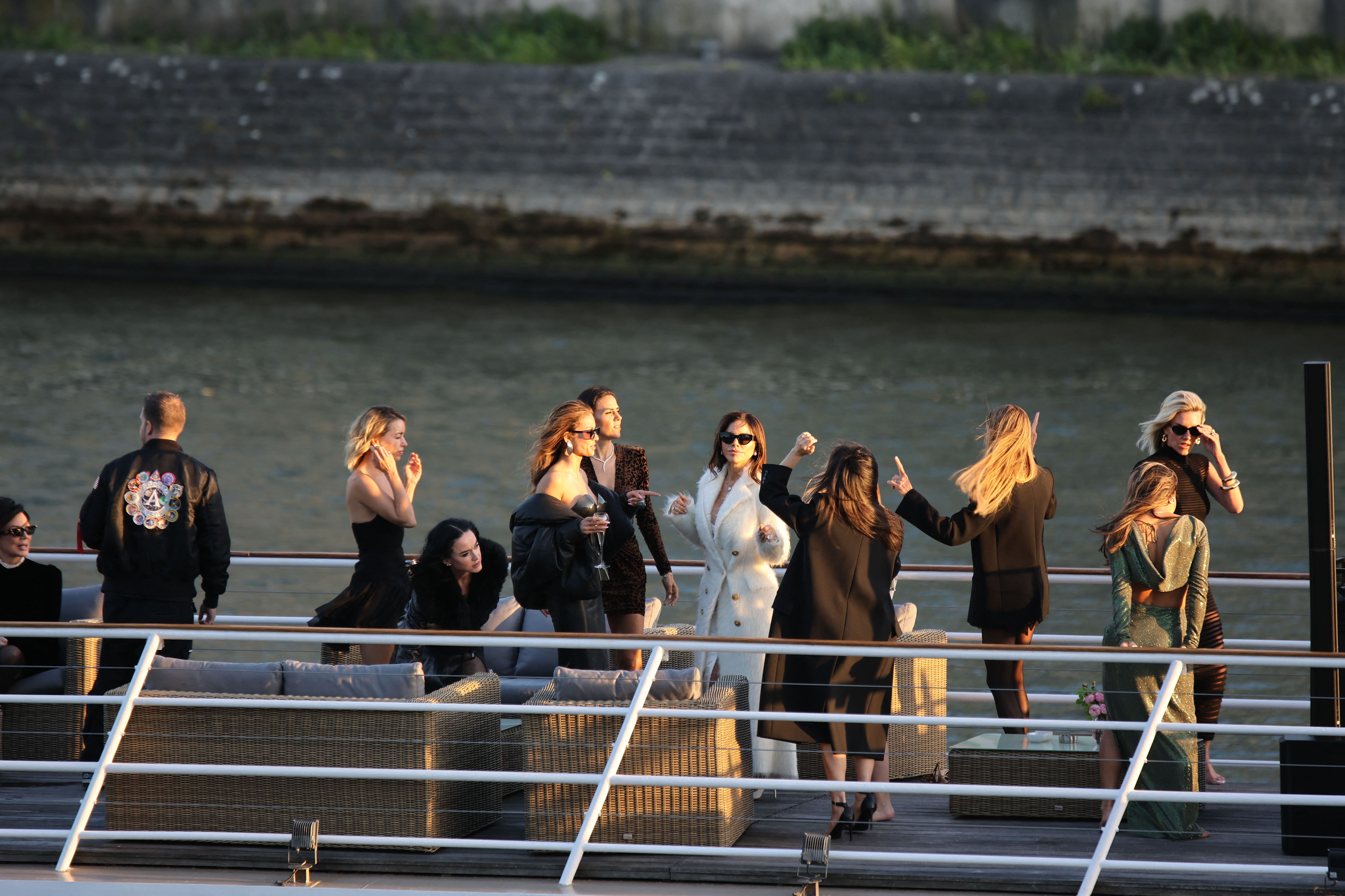 Guests dance on a boat. 