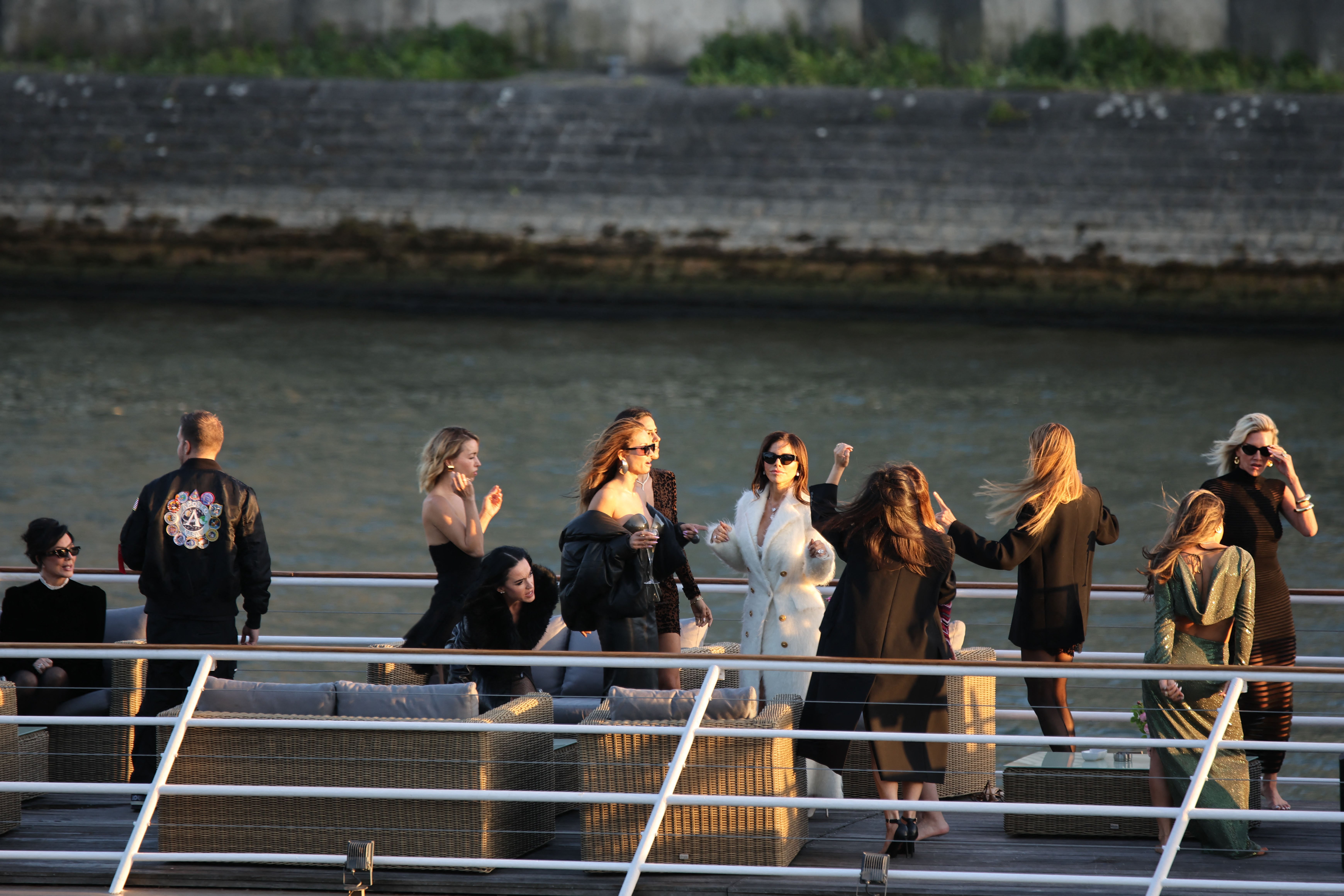 Lauren Sanchez in a coat on a boat in Paris. 