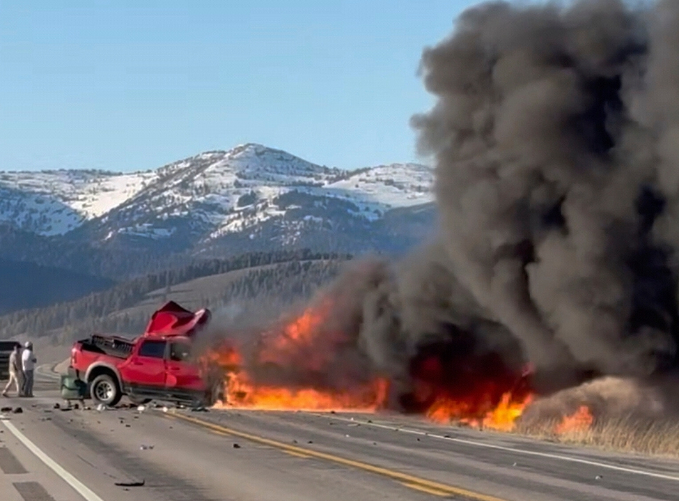 Smoke and flames billow into the air from the pickup truck and tourist van after a crash near Henry's Lake State Park in eastern Idaho on May 1, 2025.
