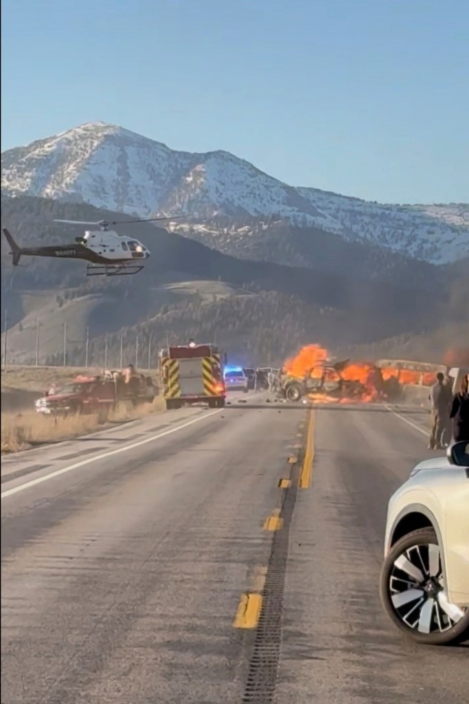 A helicopter approaches the scene of the fiery crash as first responders fight the fire of the deadly crash near Yellowstone National Park.