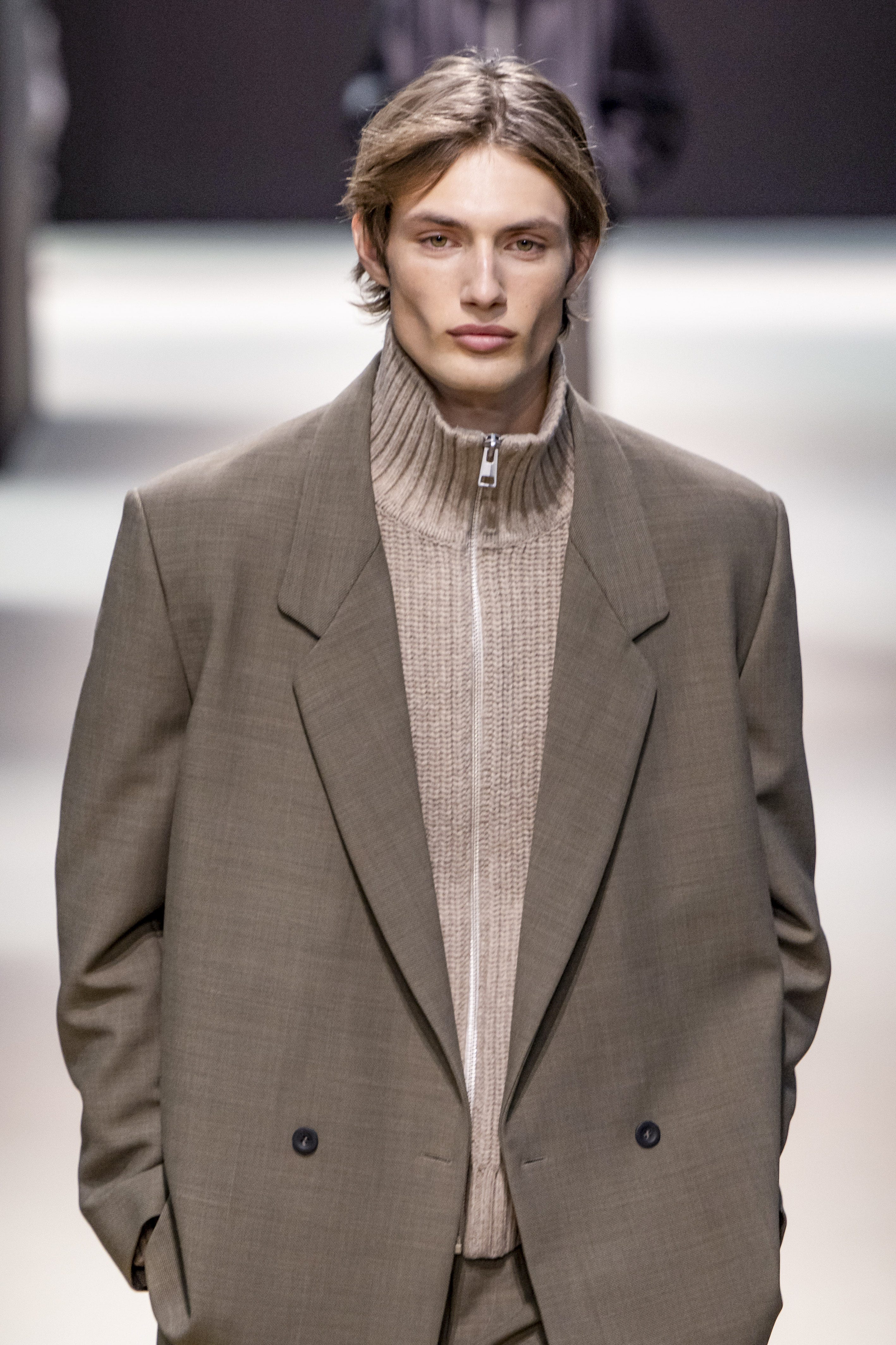 A model walks the 2024 COS runway in winter menswear.