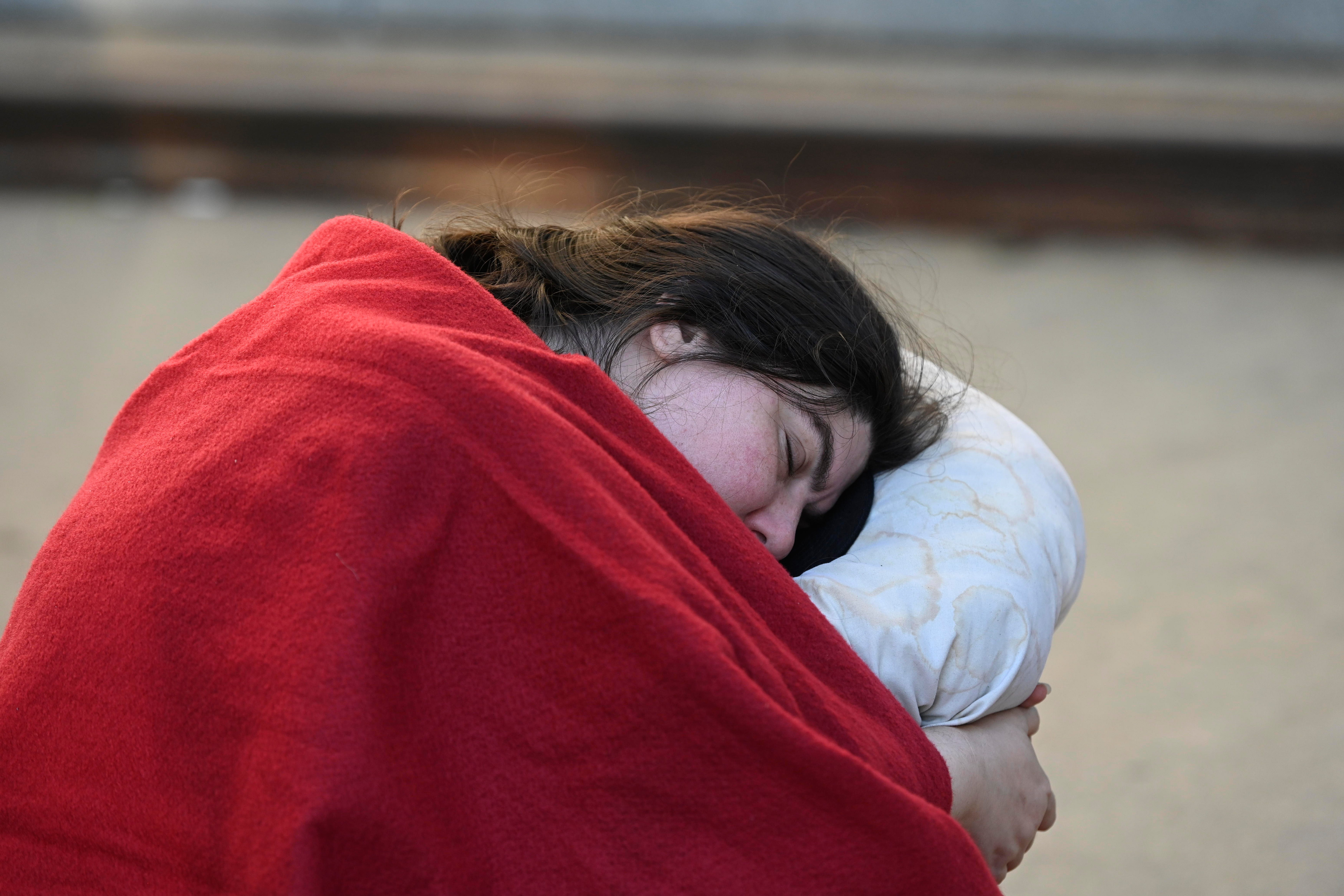 A woman sleeping in line