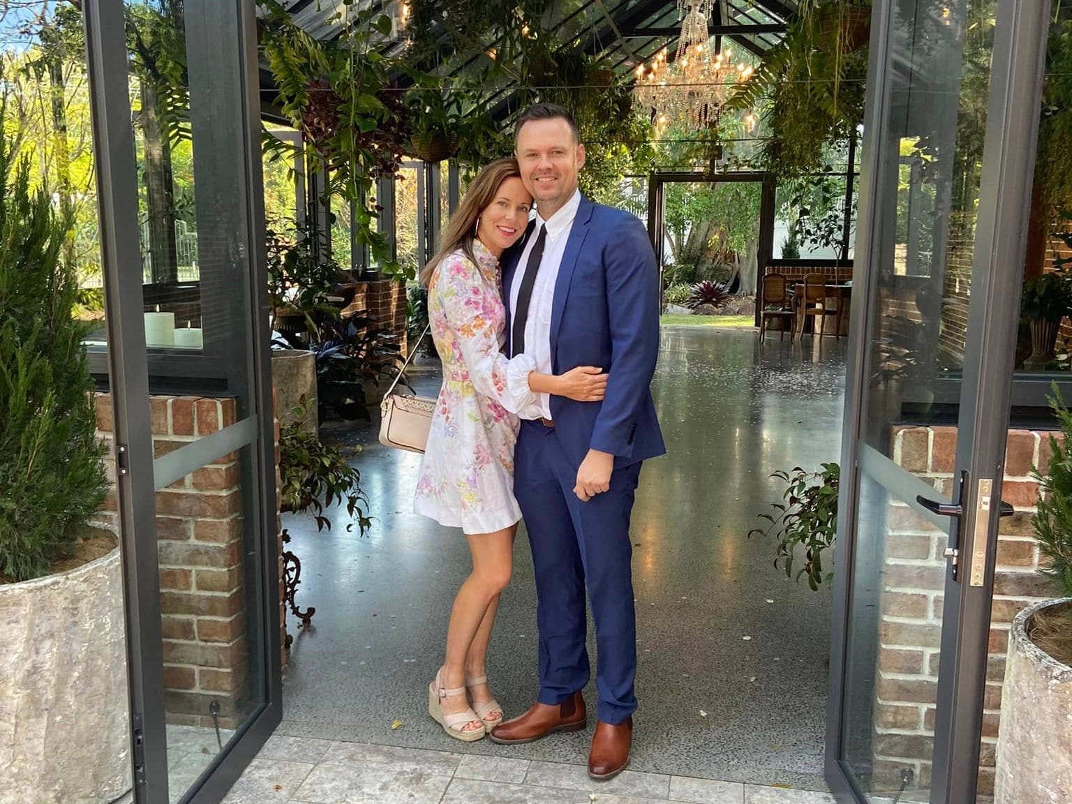 The author and her husband standing in the doorway of a wedding venue.
