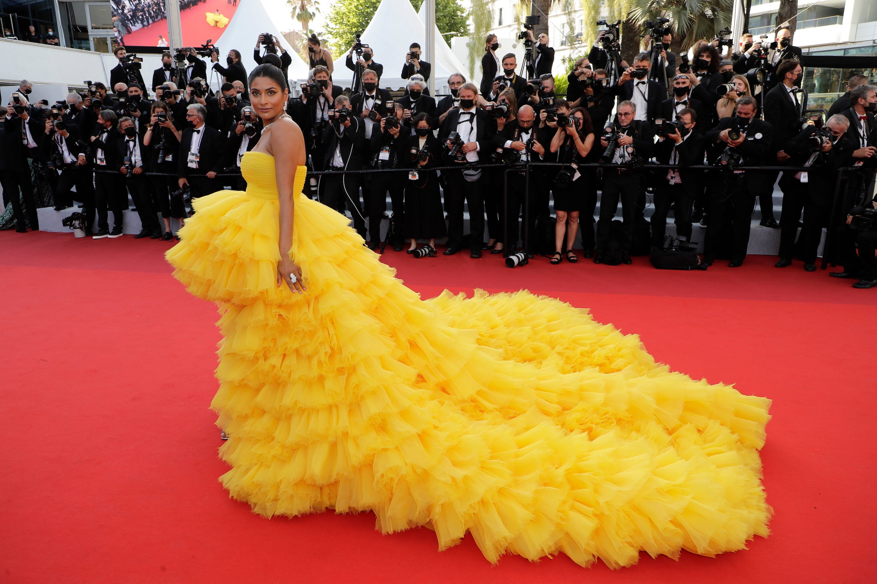 Farhana Bodi poses in a fluffy yellow dress at the Cannes Film Festival.
