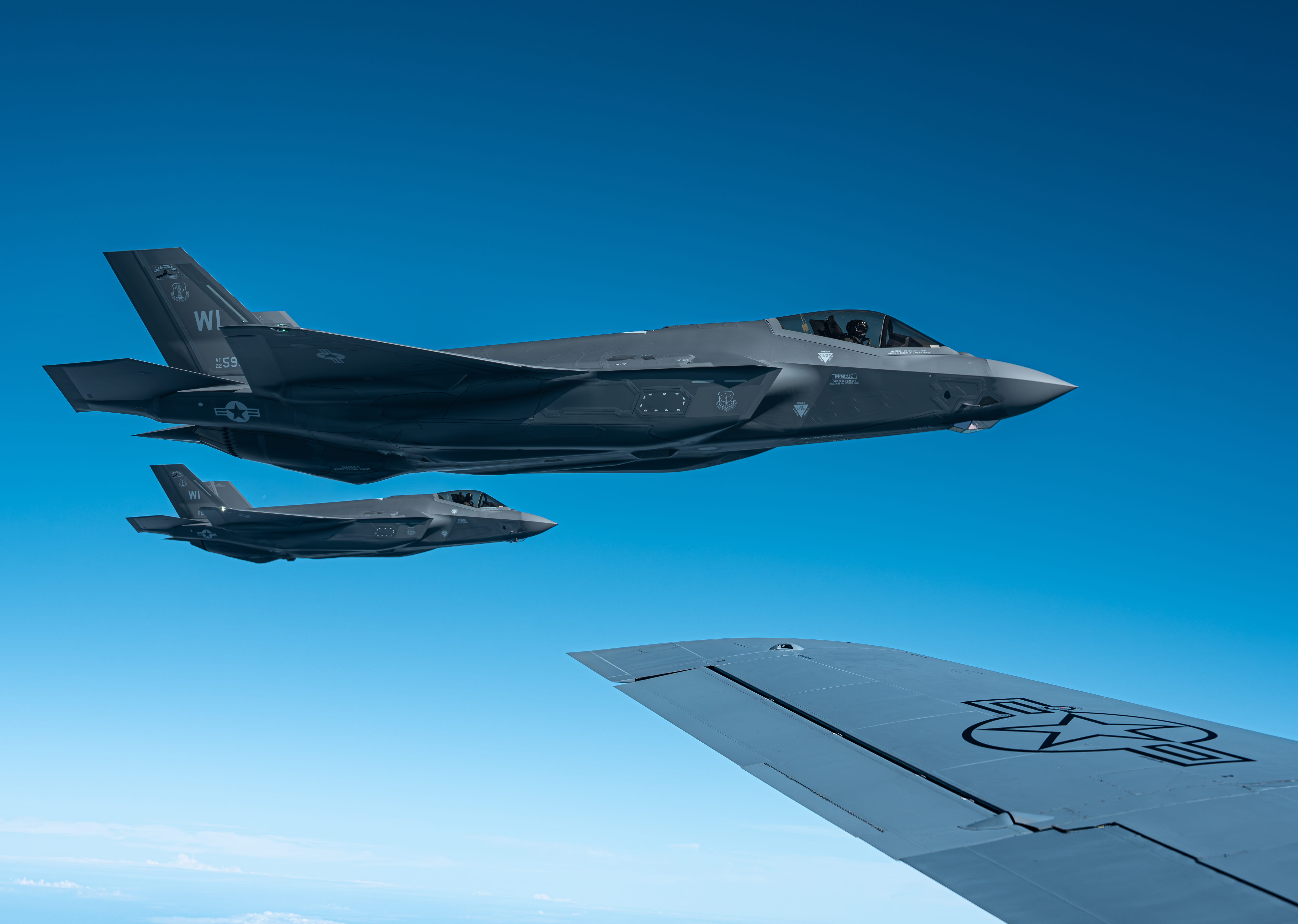 A team of F-35A Lighting II aircraft assigned to the 115th Fighter Wing, Wisconsin Air National Guard, fly of the wing tip of a KC-135 stratotanker aircraft, assigned to the 171st Air Refueling Wing, Pennsylvania Air National Guard during a routine training mission, May 14, 2025.
