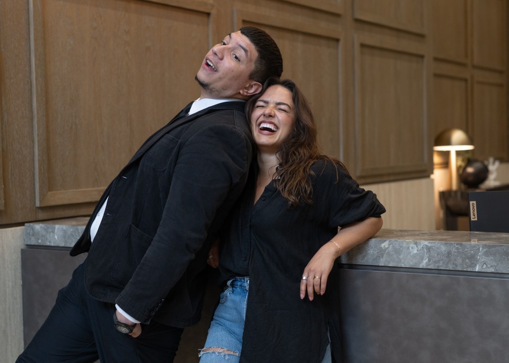 Abigail Olshavsky and Wilbey Martinez posing together laughing in Park Slope, Brooklyn, building, Photo by J.C. Rice