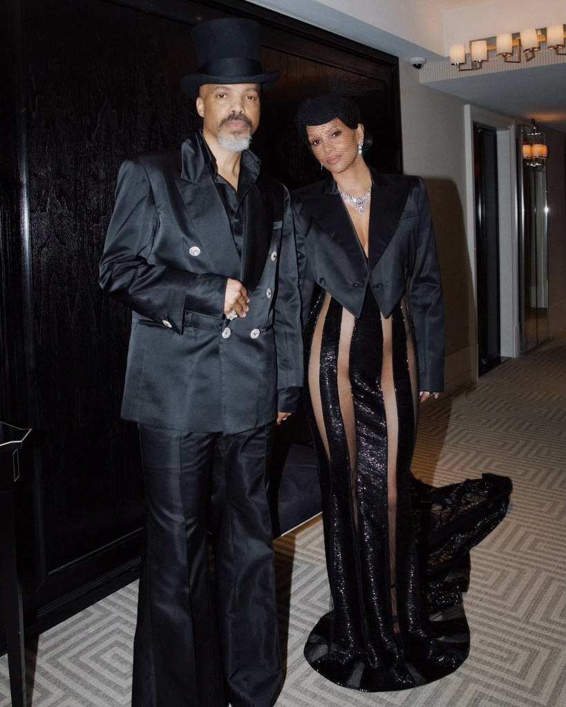 Halle Berry in a cropped black satin jacket, sheer black gown with black panels.