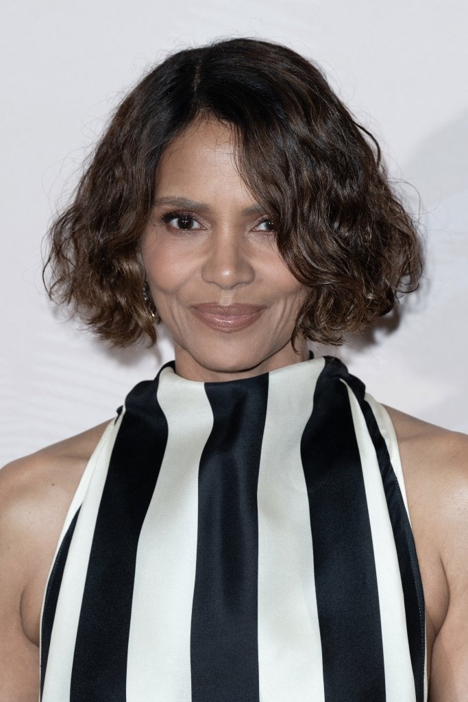 Halle Berry in a long black and white striped halter neck gown.