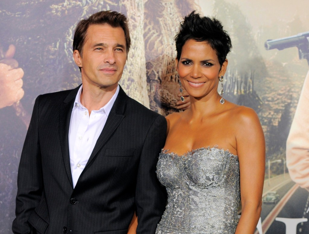 Halle Berry in a grey lace bustier, Olivier Martinez in a black blazer and white shirt.