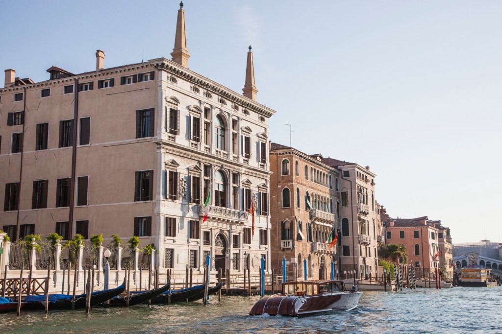 Aman Venice hotel with the gondolas of venice in front