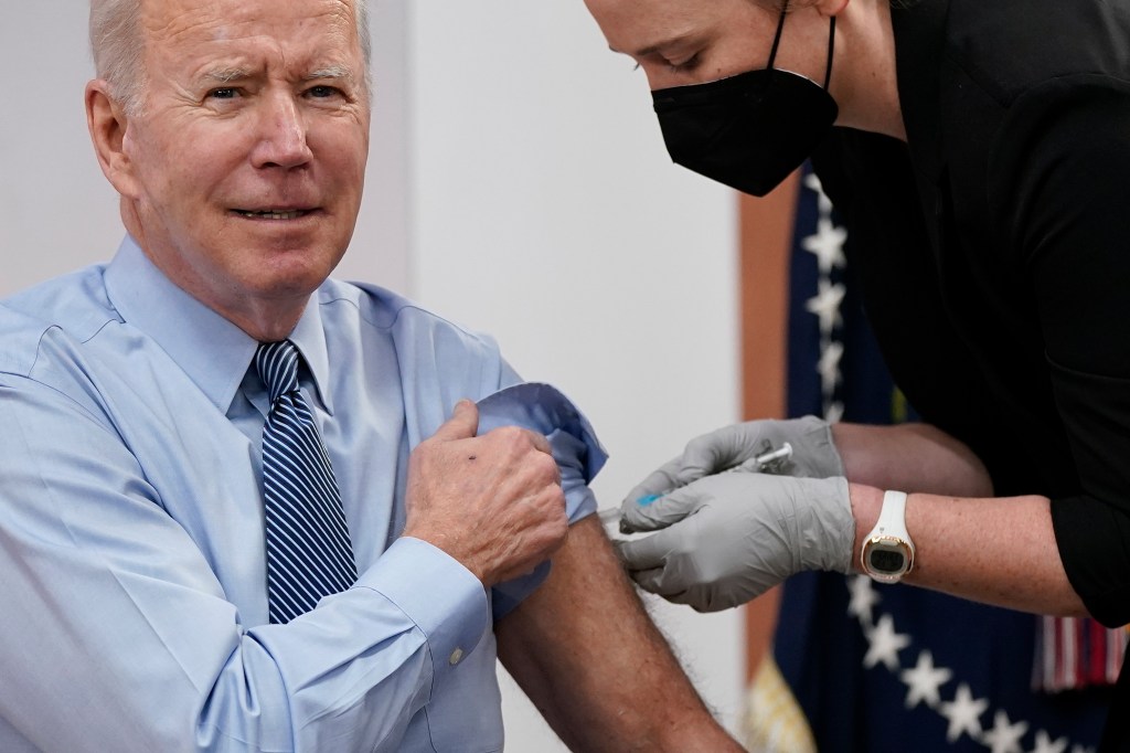 President Joe Biden receives his second COVID-19 booster shot in the South Court Auditorium on the White House campus, Wednesday, March 30, 2022, in Washington. (AP Photo/Patrick Semansky)
Joe Biden