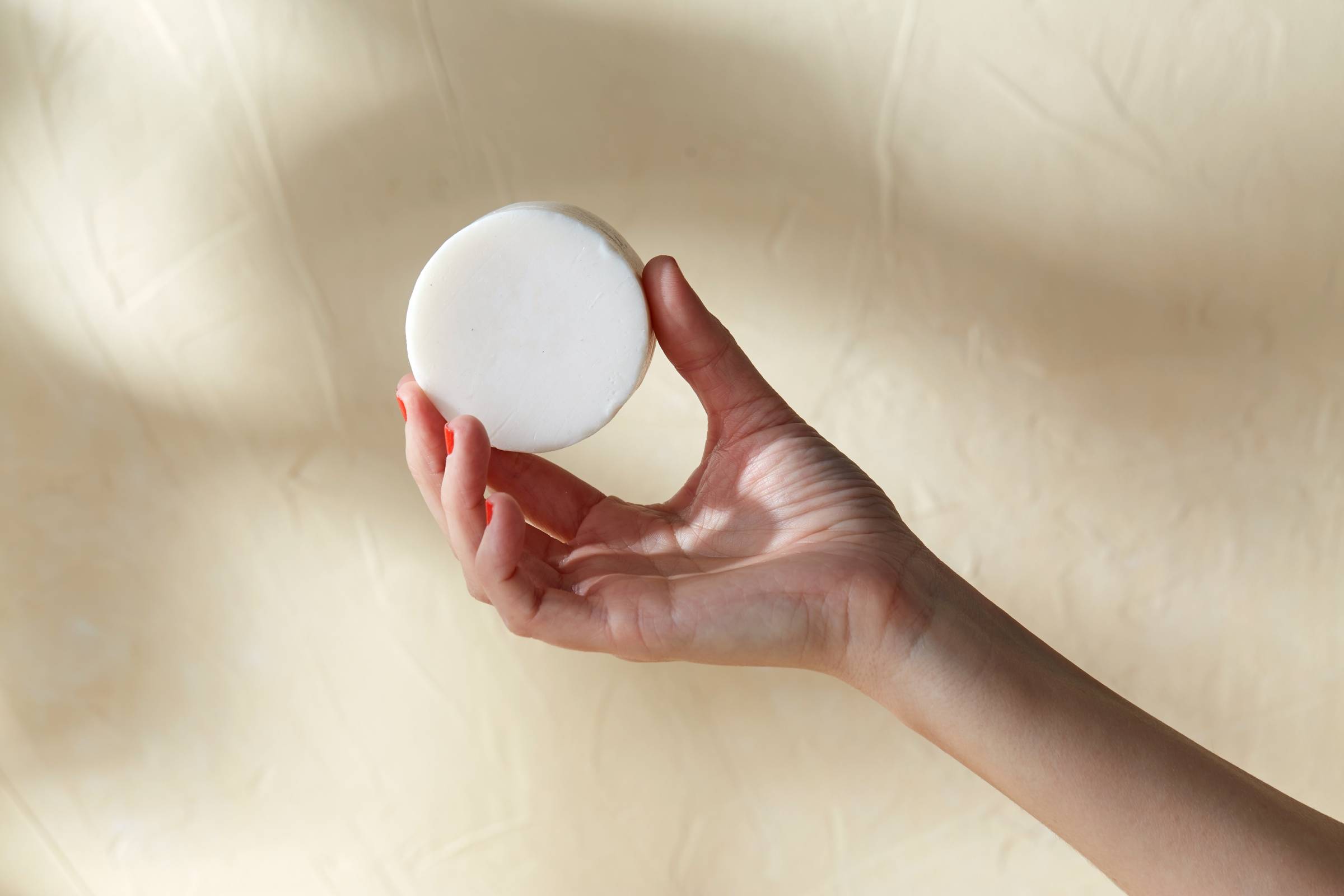 hand holding circular bar of soap