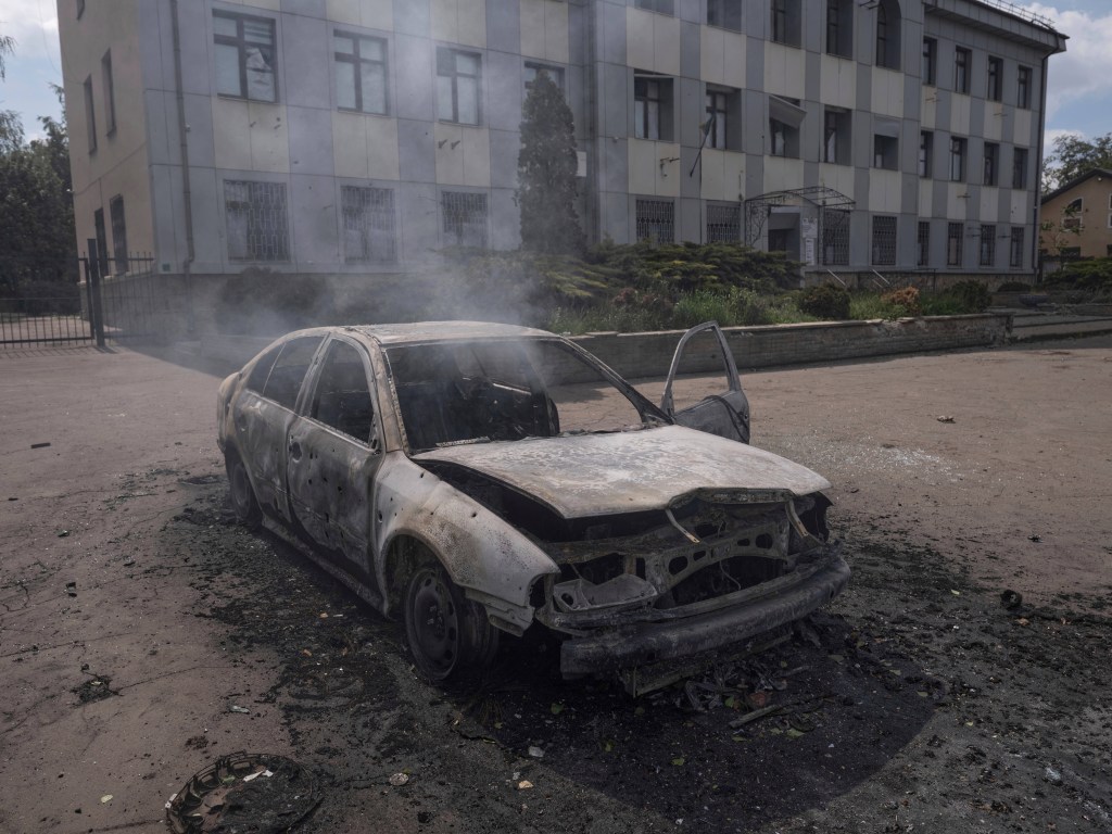 A torched car that was hit with a drone strike. 