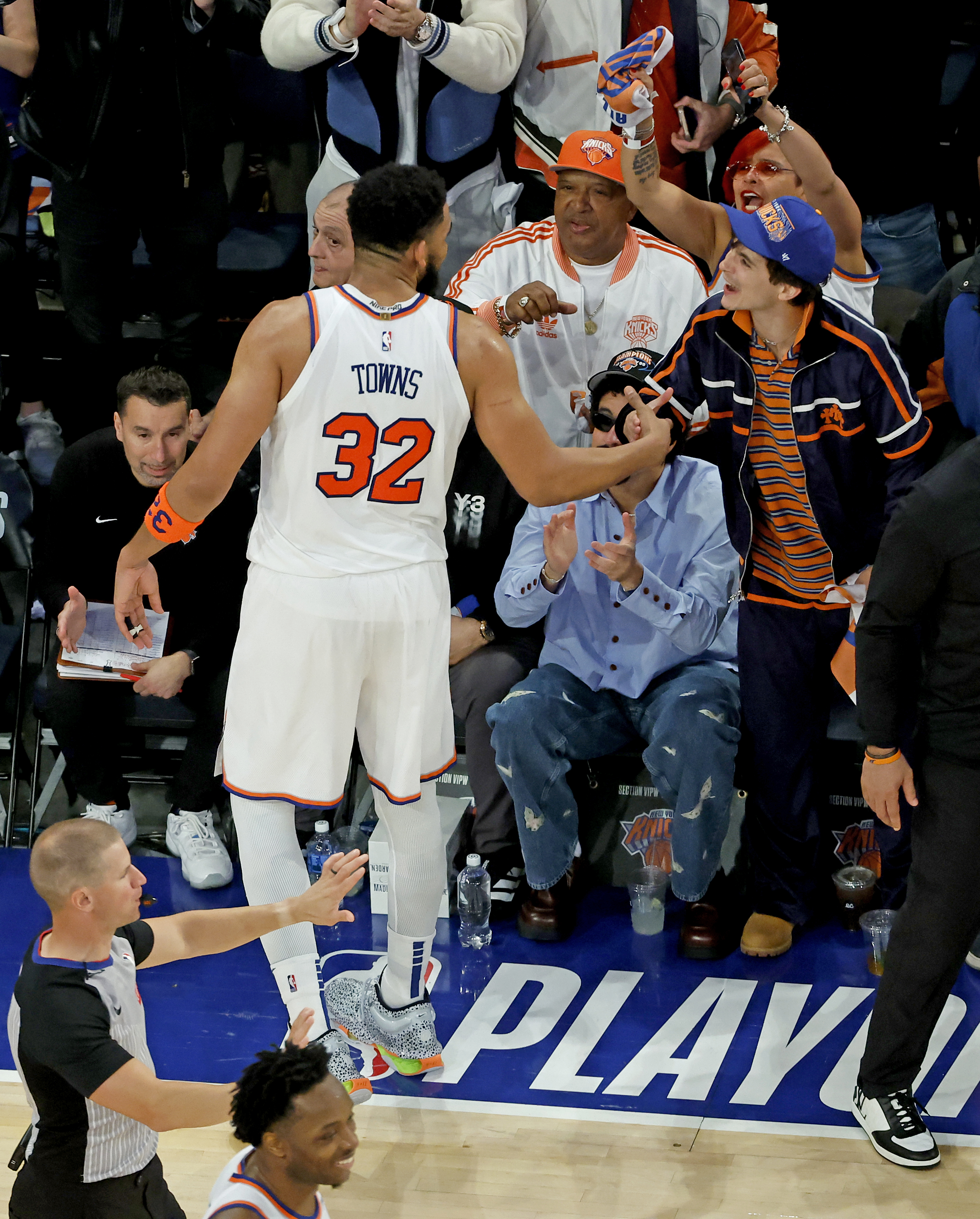 Karl-Anthony Towns grabbing Timothée Chalamet's hand.