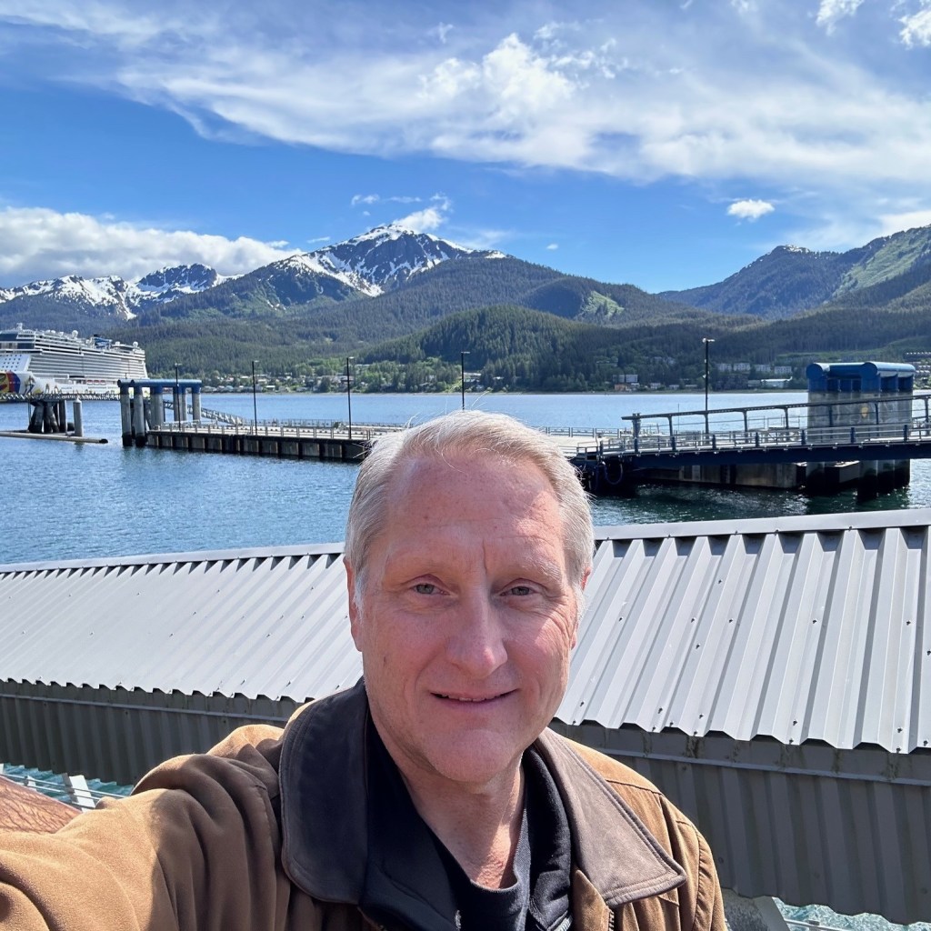 Social media selfie of Dr. Steve Burgess with mountains in background during travels.