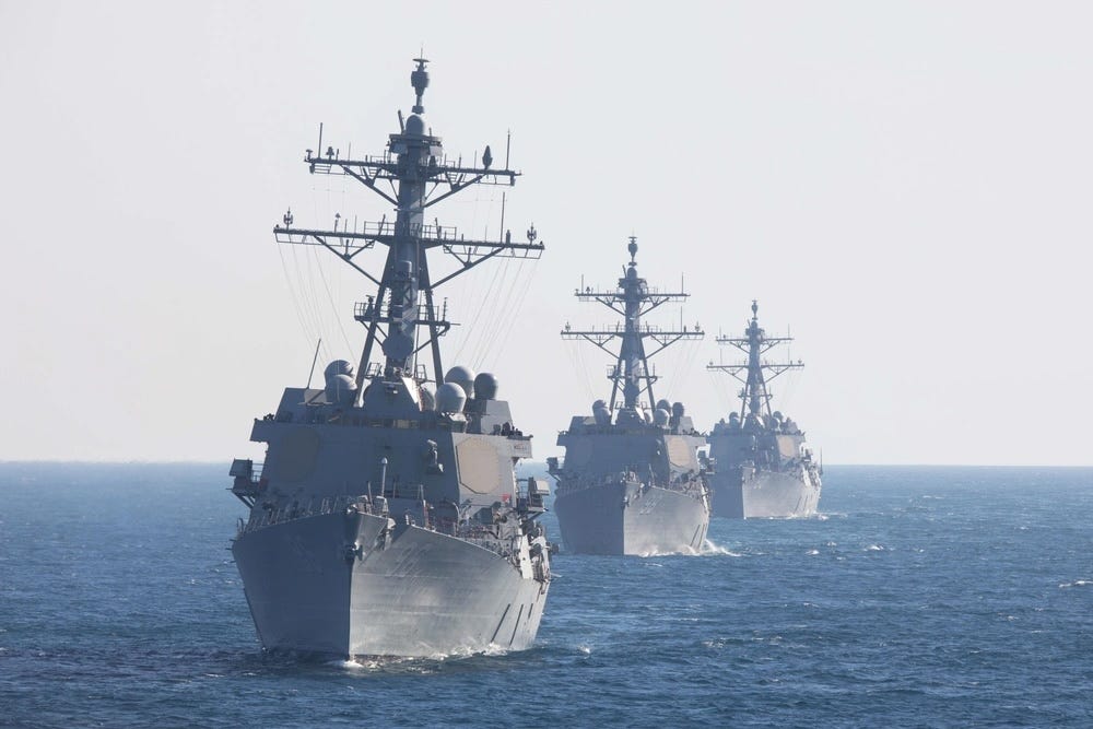 Arleigh Burke-class guided-missile destroyers USS Bainbridge, USS Forrest Sherman, and USS Roosevelt transit the Atlantic Ocean in formation.