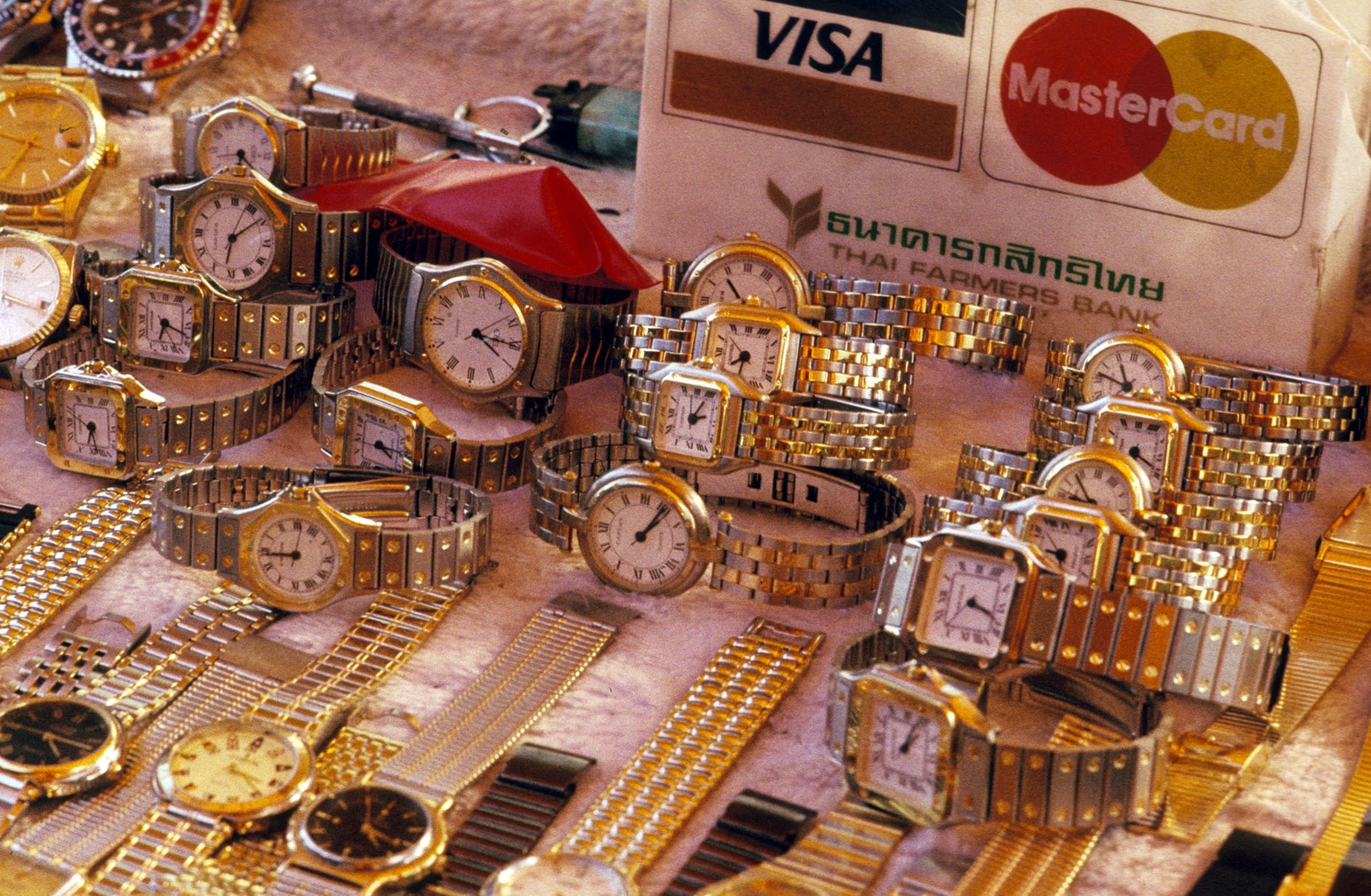 Counterfeit watches laying on a table