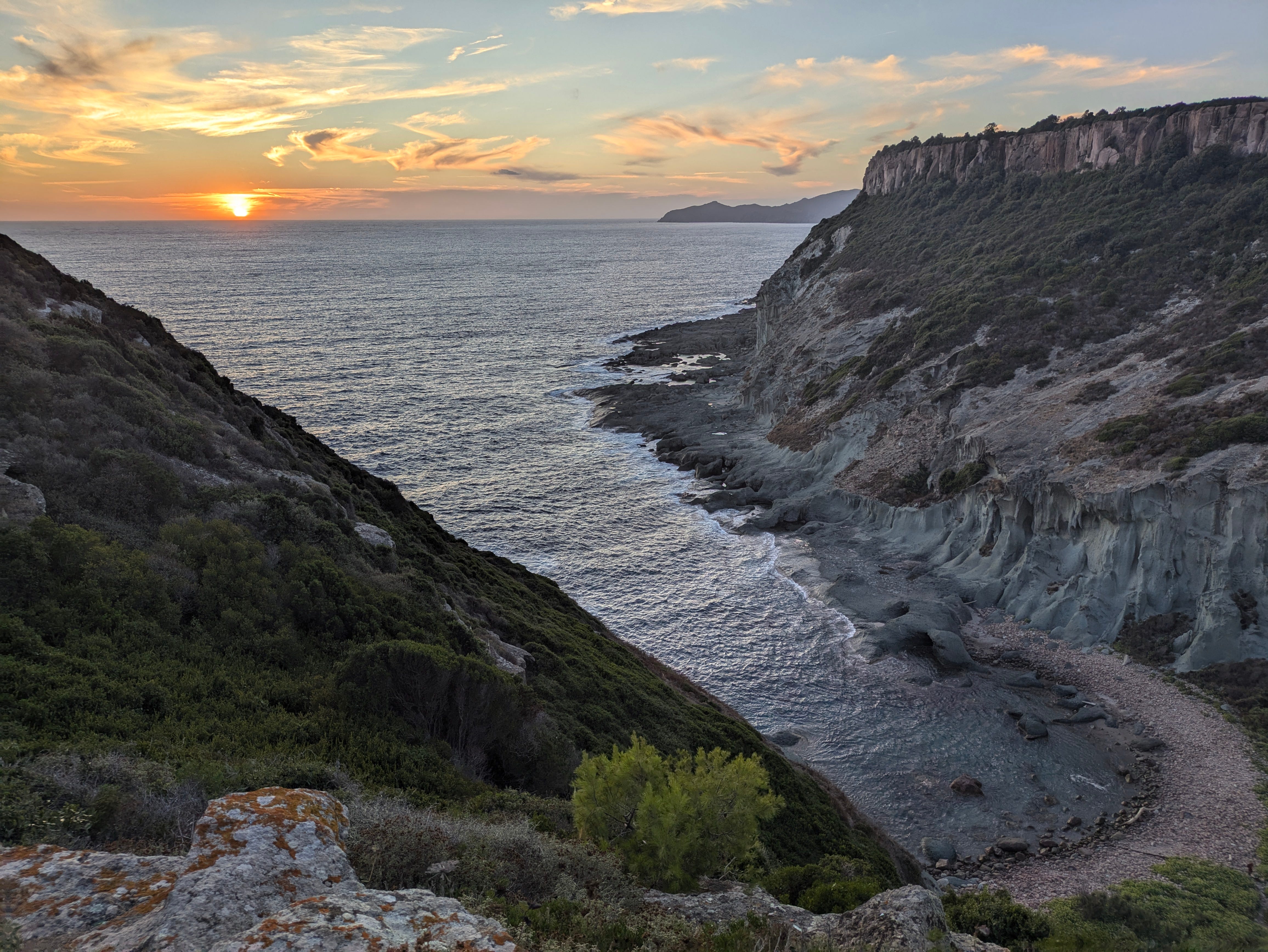 A sunset over the water near the author's house in Bosa.