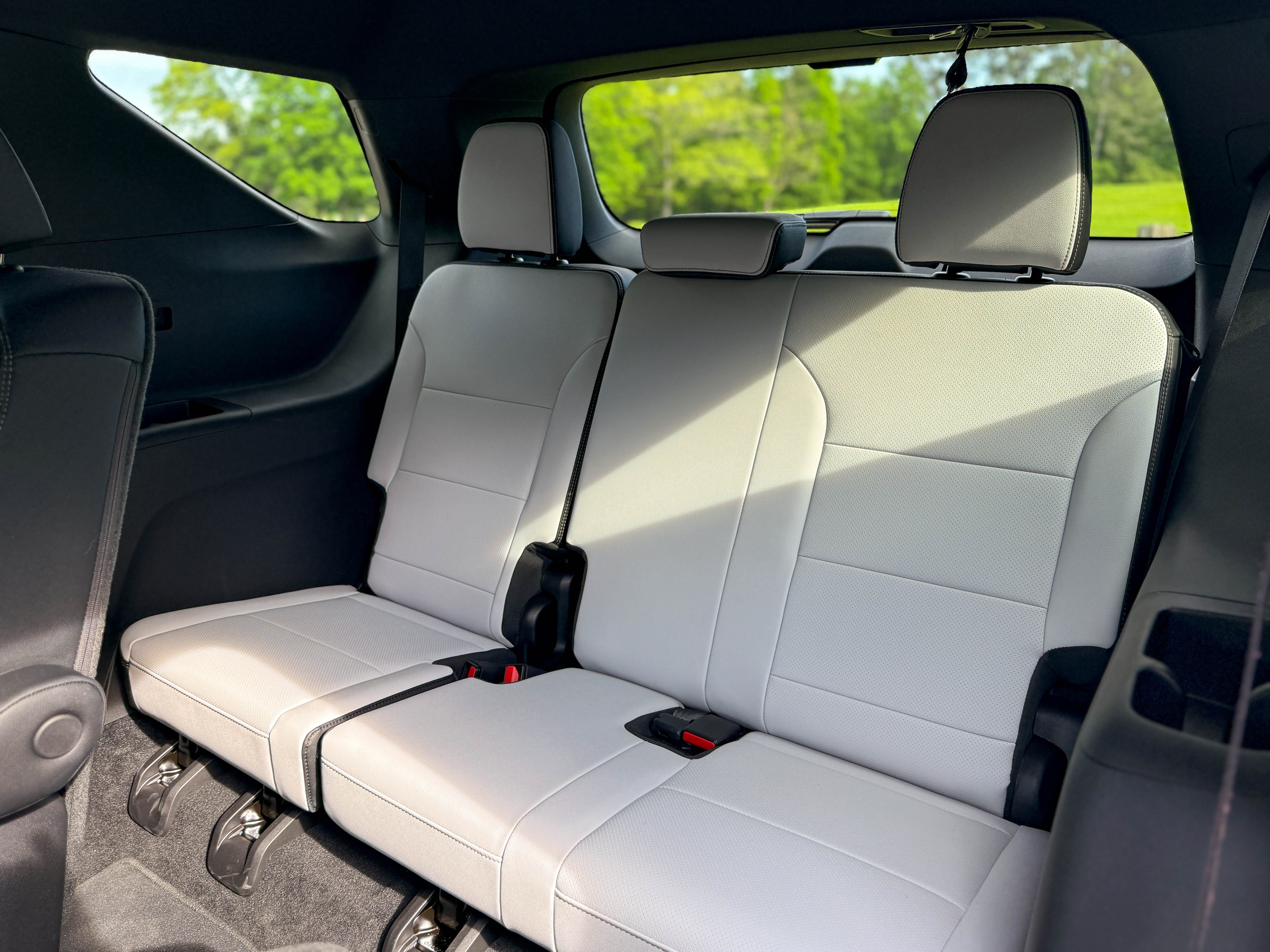 The white leather third row bench seat in a 2025 Chevrolet Traverse High Country midsize family SUV.