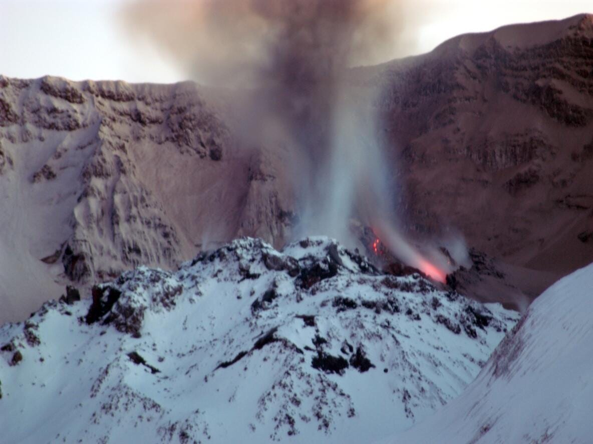 The dome of Mount St. Helens' crater full of snow and glowing red hot