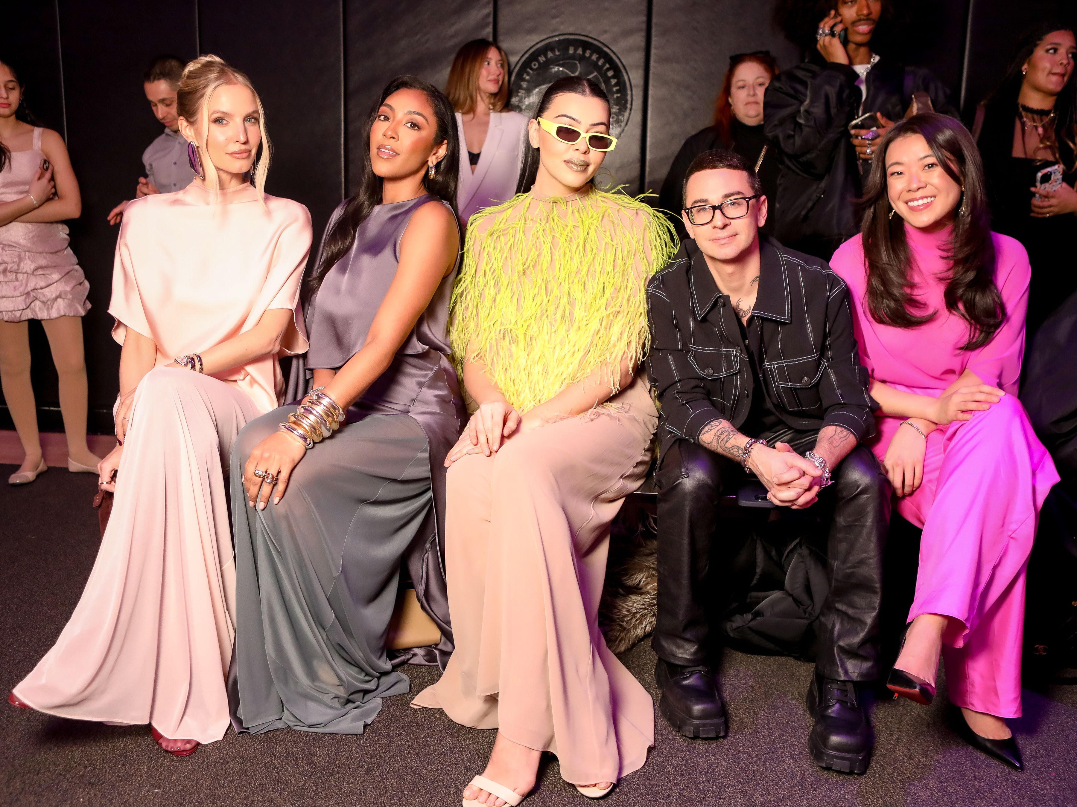 Lauren Chan, Christian Siriano front row at a fashion show. 