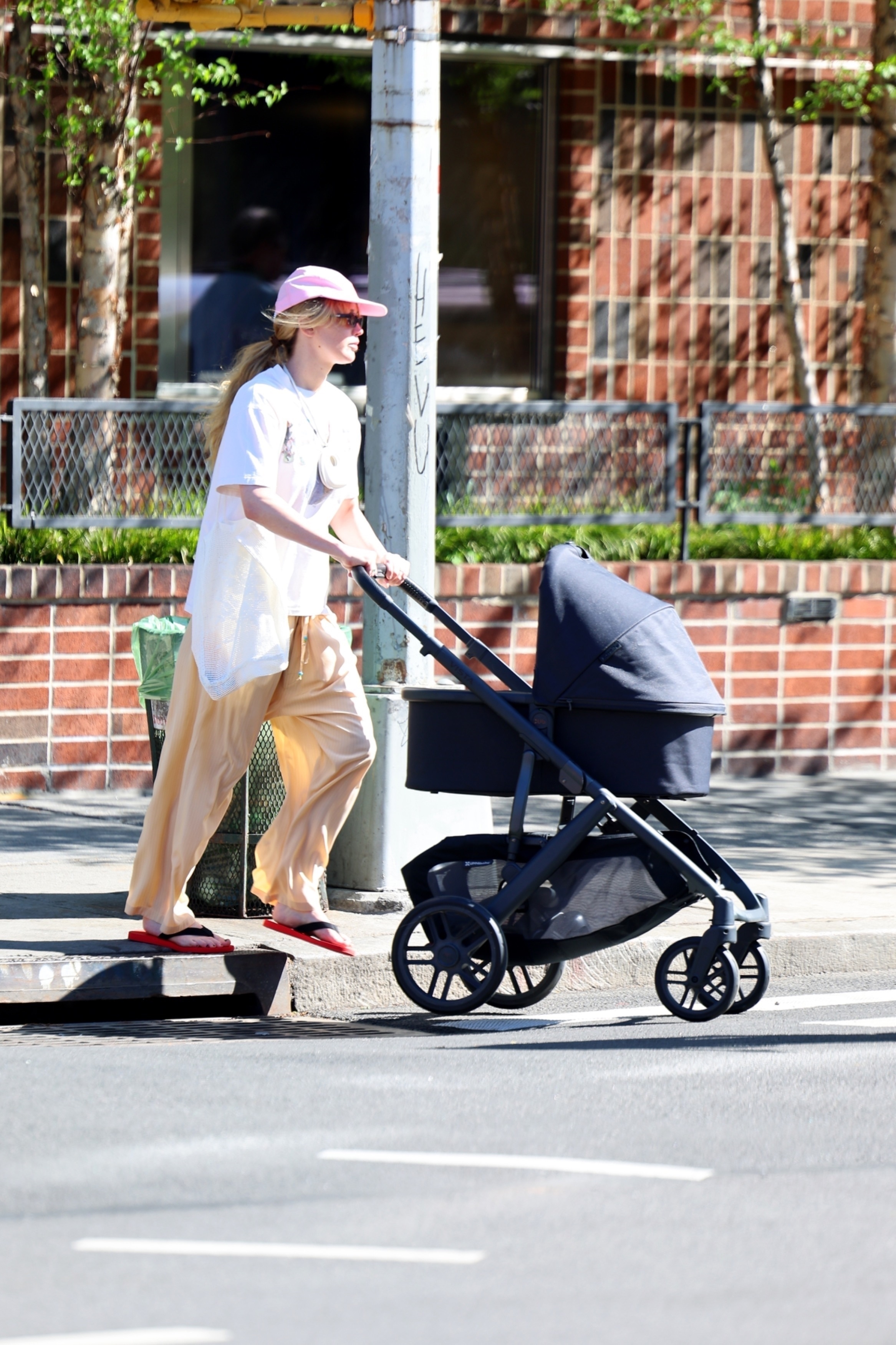 Jennifer Lawrence pushing her baby in a stroller in 2025