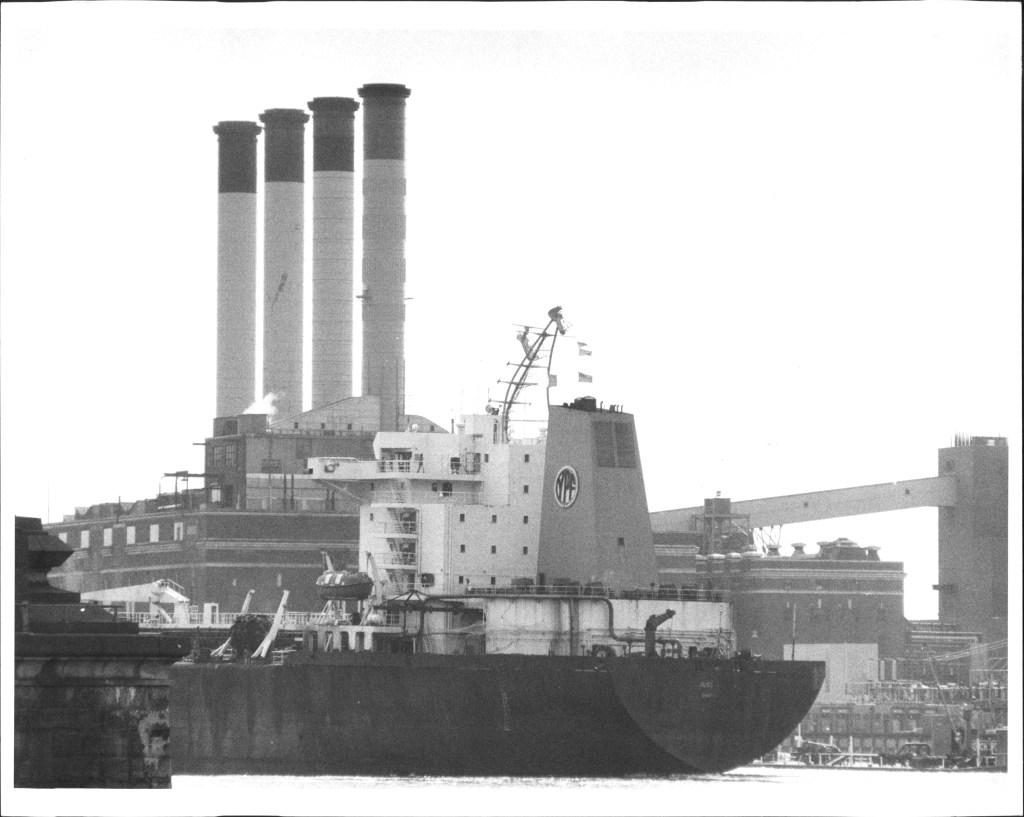 Tanker sailing up the East River with a bent mast after colliding with the Brooklyn Bridge on April 18, 1986
