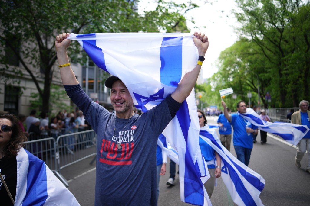 The attendees waved around Israeli flags as they marched on Fifth Avenue.