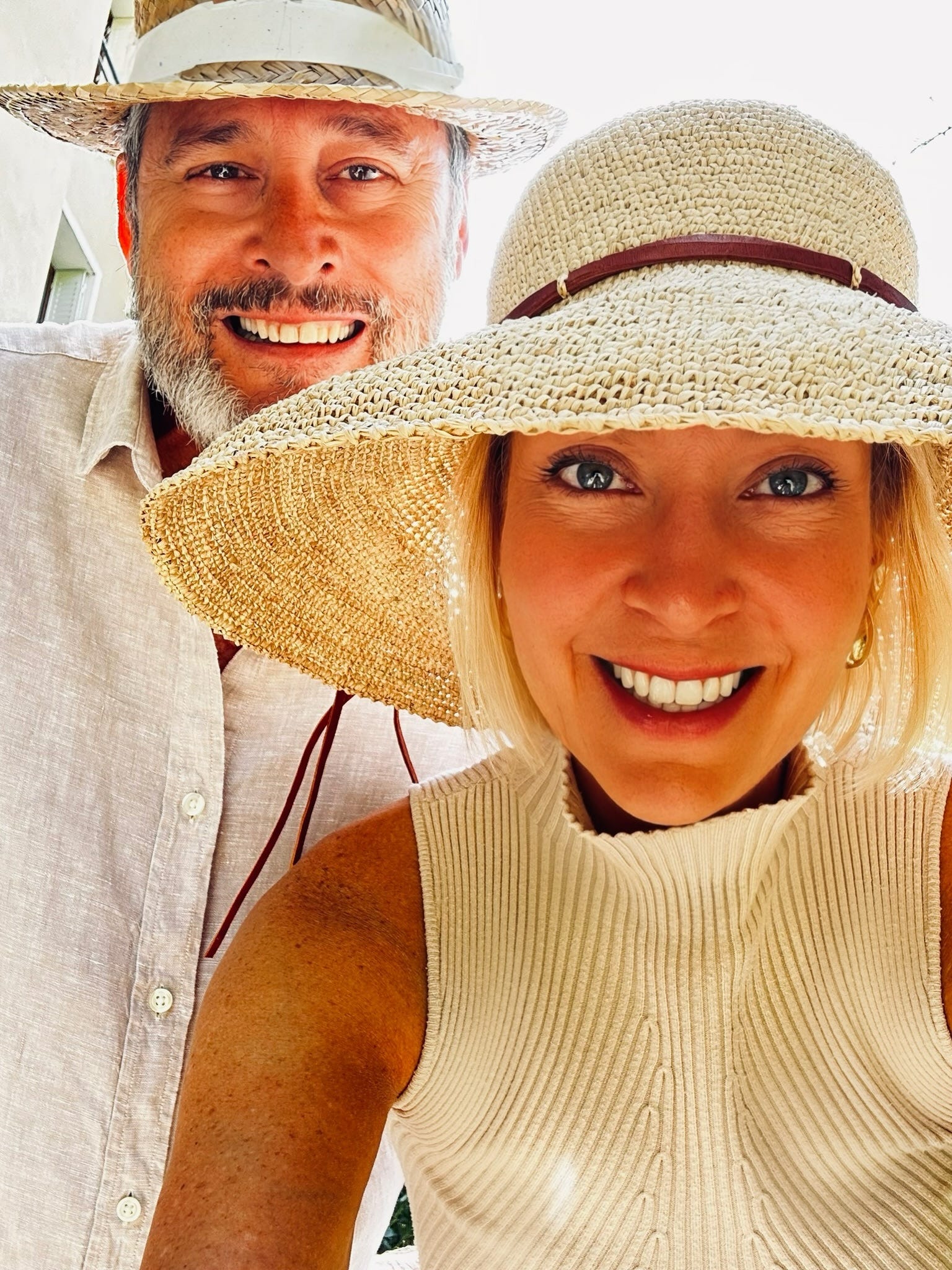 A man and a woman wearing sun hats.