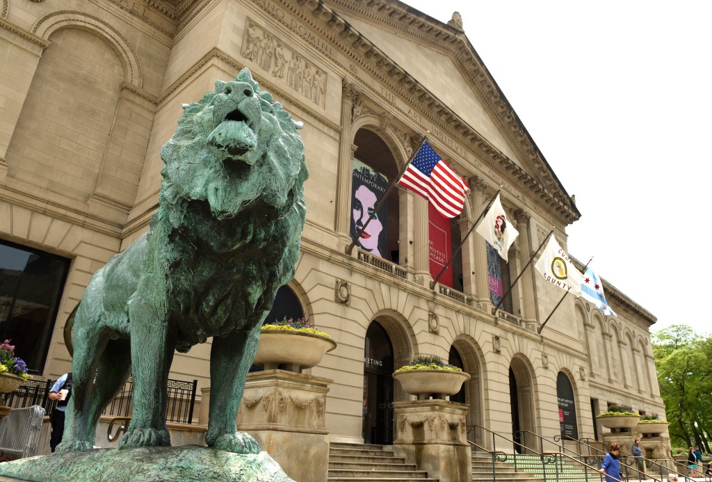 Outside of an art museum with a lion in the foreground