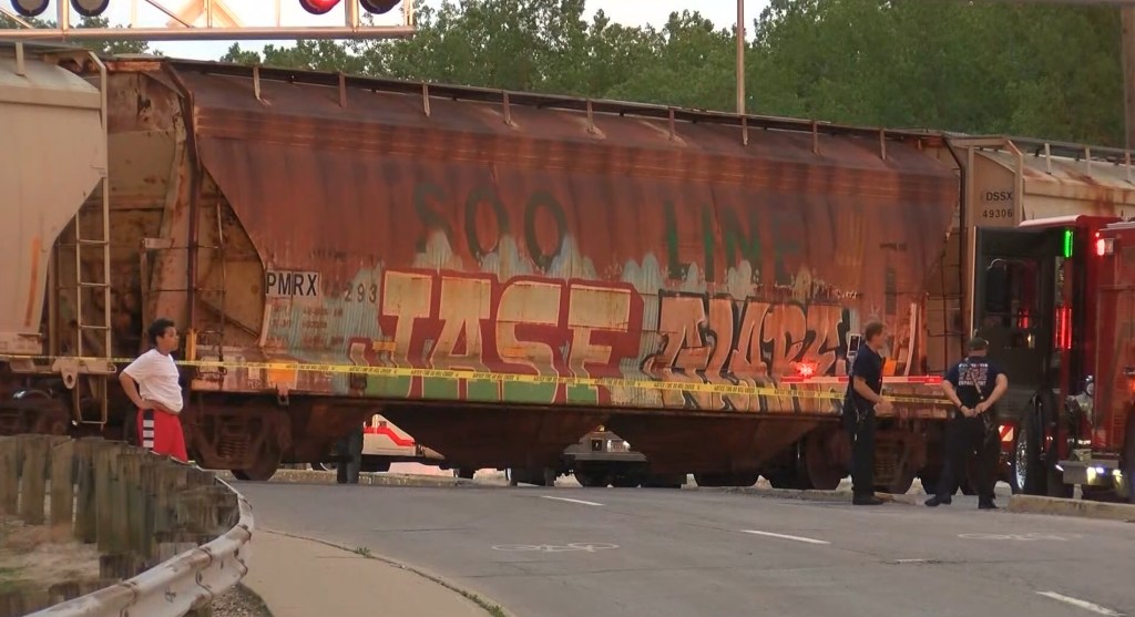Firefighters stand near a car of the train in the aftermath of the deadly crash.