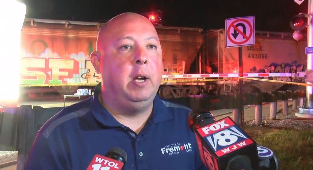 Freemont Mayor Danny Sanchez gives an update in front of the train.