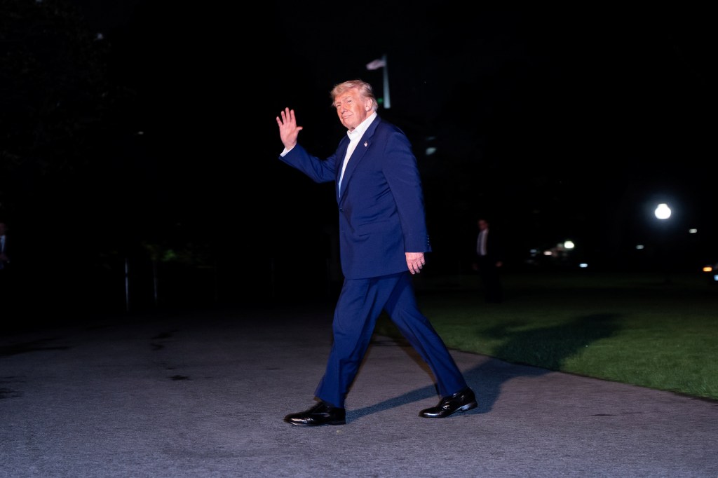 Donald Trump waves as he arrives back at the White House after his trip to the Middle East on May 16, 2025.