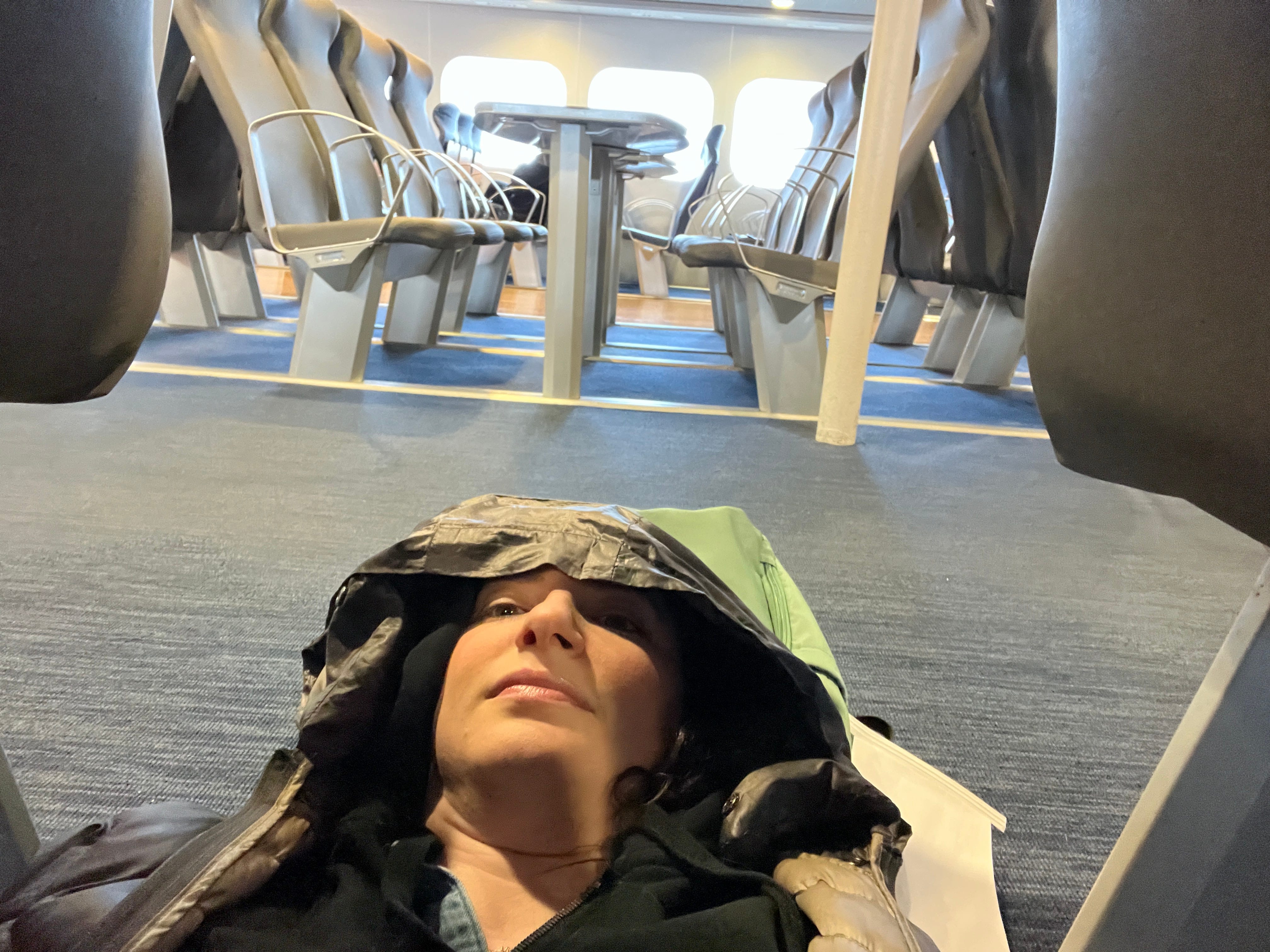 Talia Lakritz lays on the floor of the Lake Express ferry due to seasickness.
