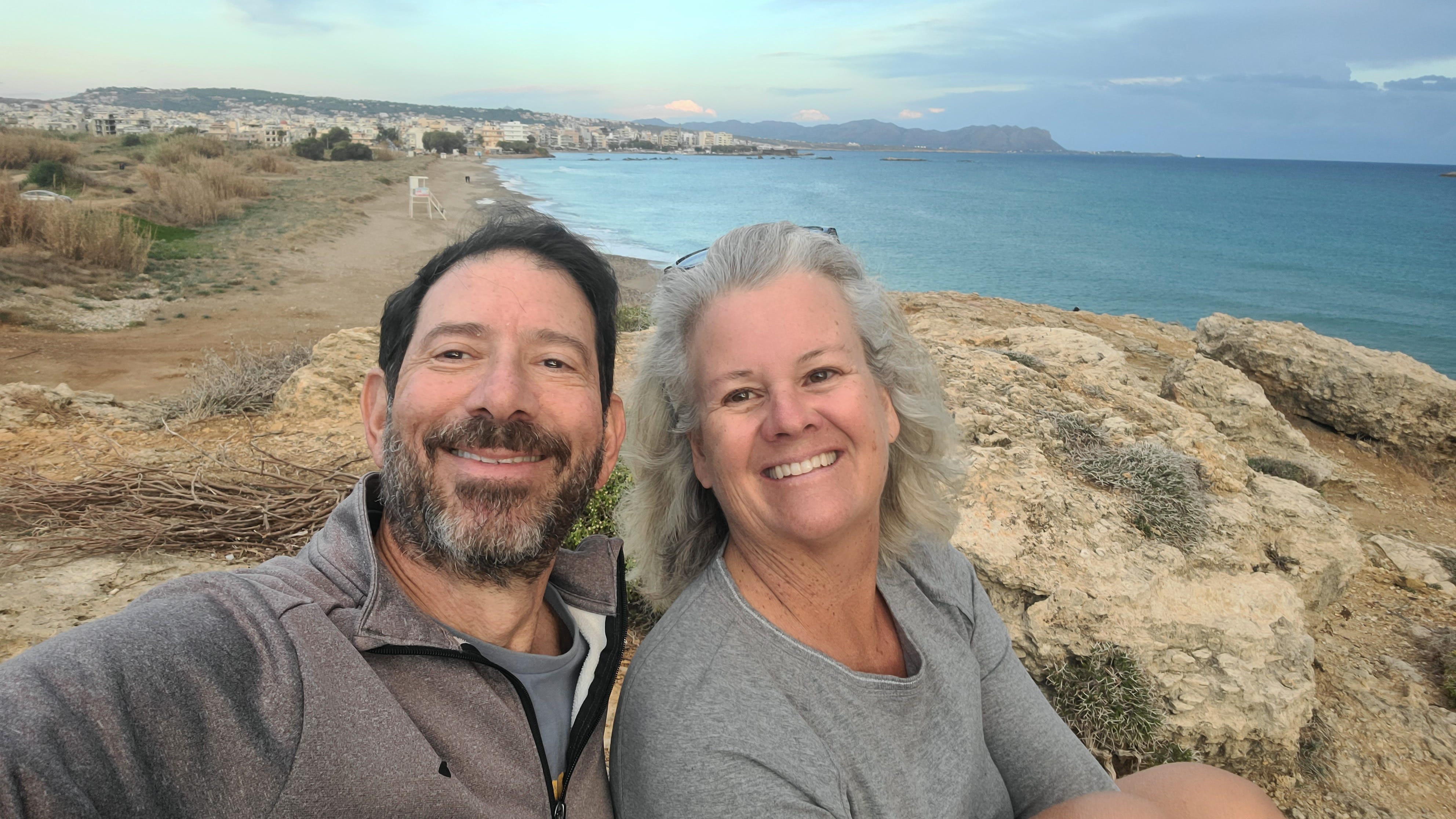 Author Chris Englert and husband smiling on beach