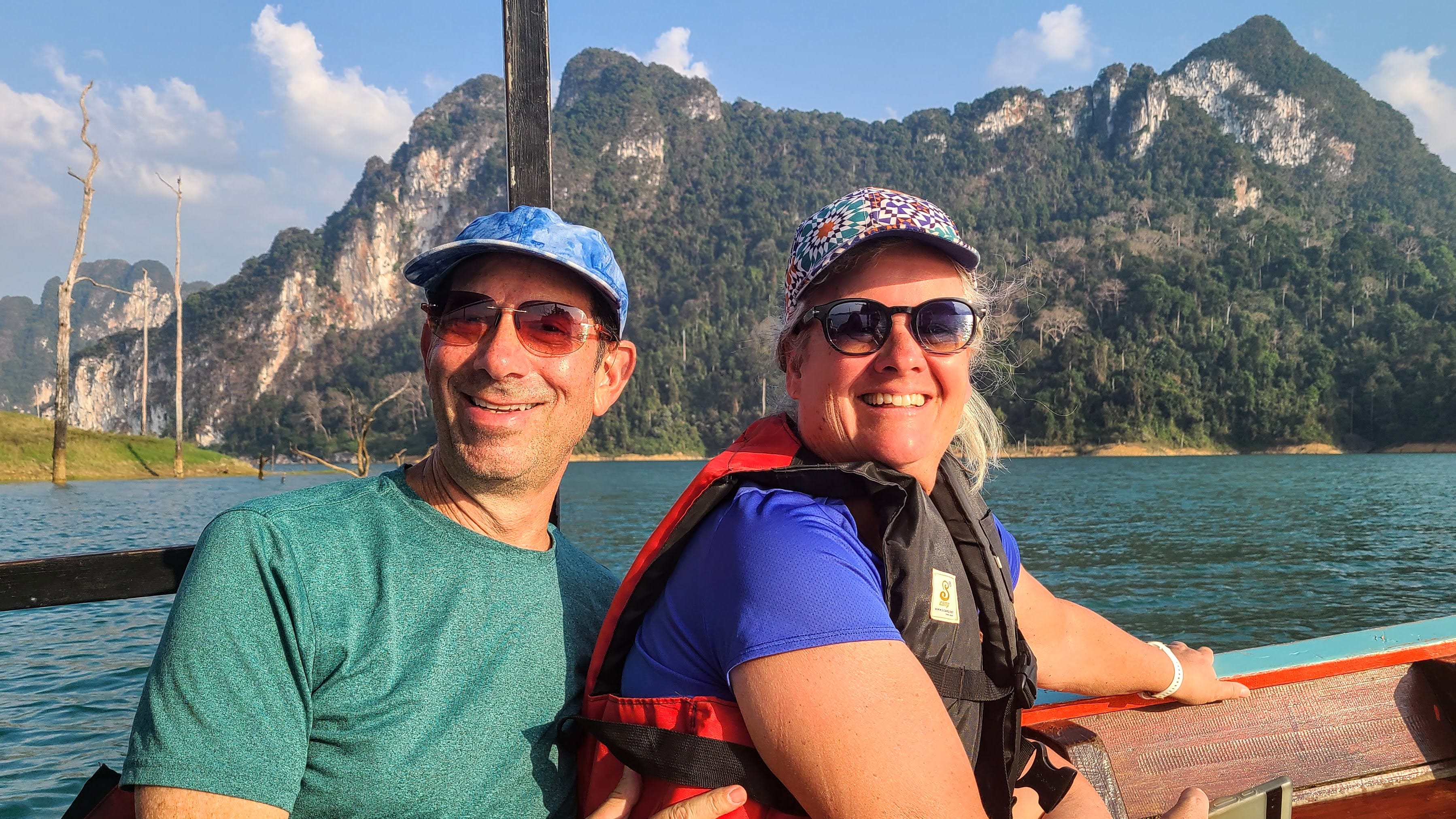 Author Chris Englert and husband smiling on boat