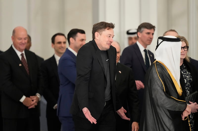 Elon Musk gestures as he arrives for a state dinner hosted by Qatar's Emir Sheikh Tamim bin Hamad Al Thani in honor of President Donald Trump.