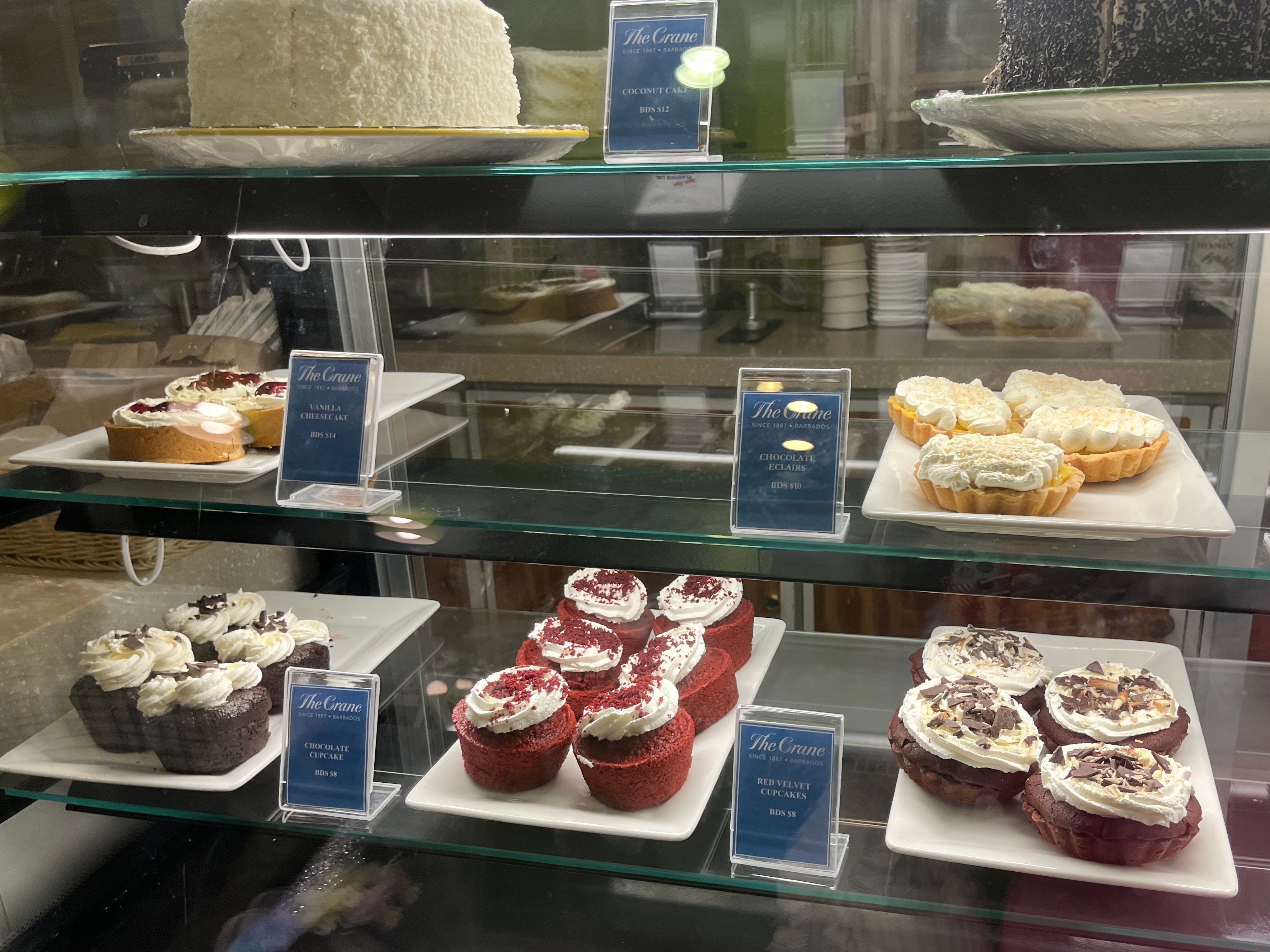 A display case of cakes and pastries.