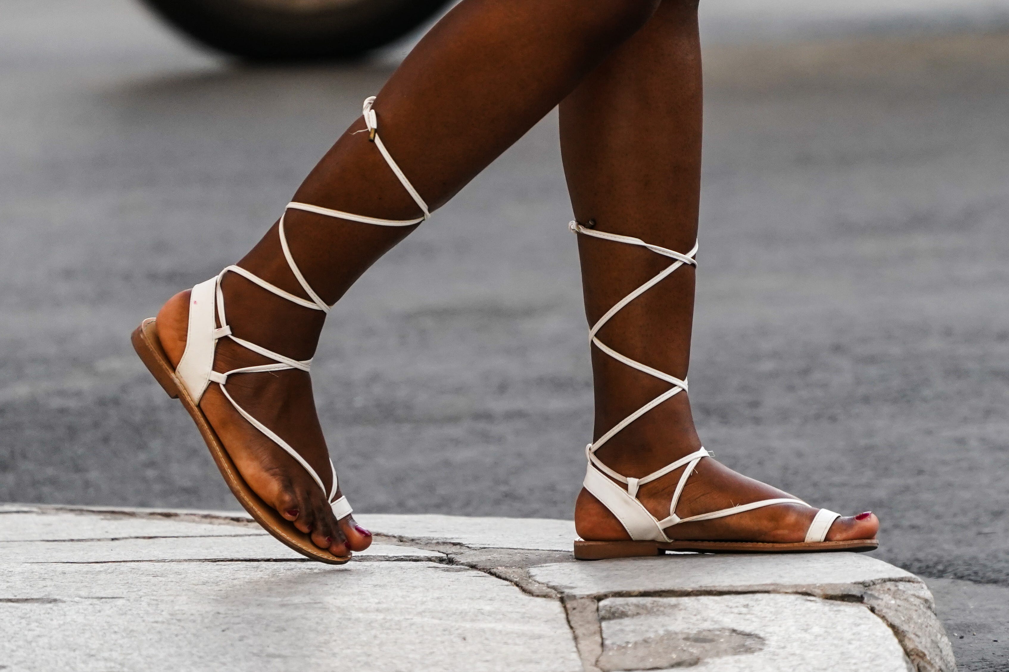 Flat, white lace-up sandals