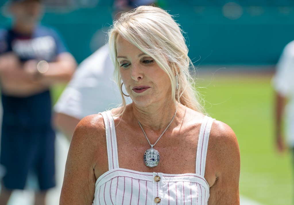 Linda Holliday wearing a New England Patriots Super Bowl LIII Championship ring necklace in 2019.
