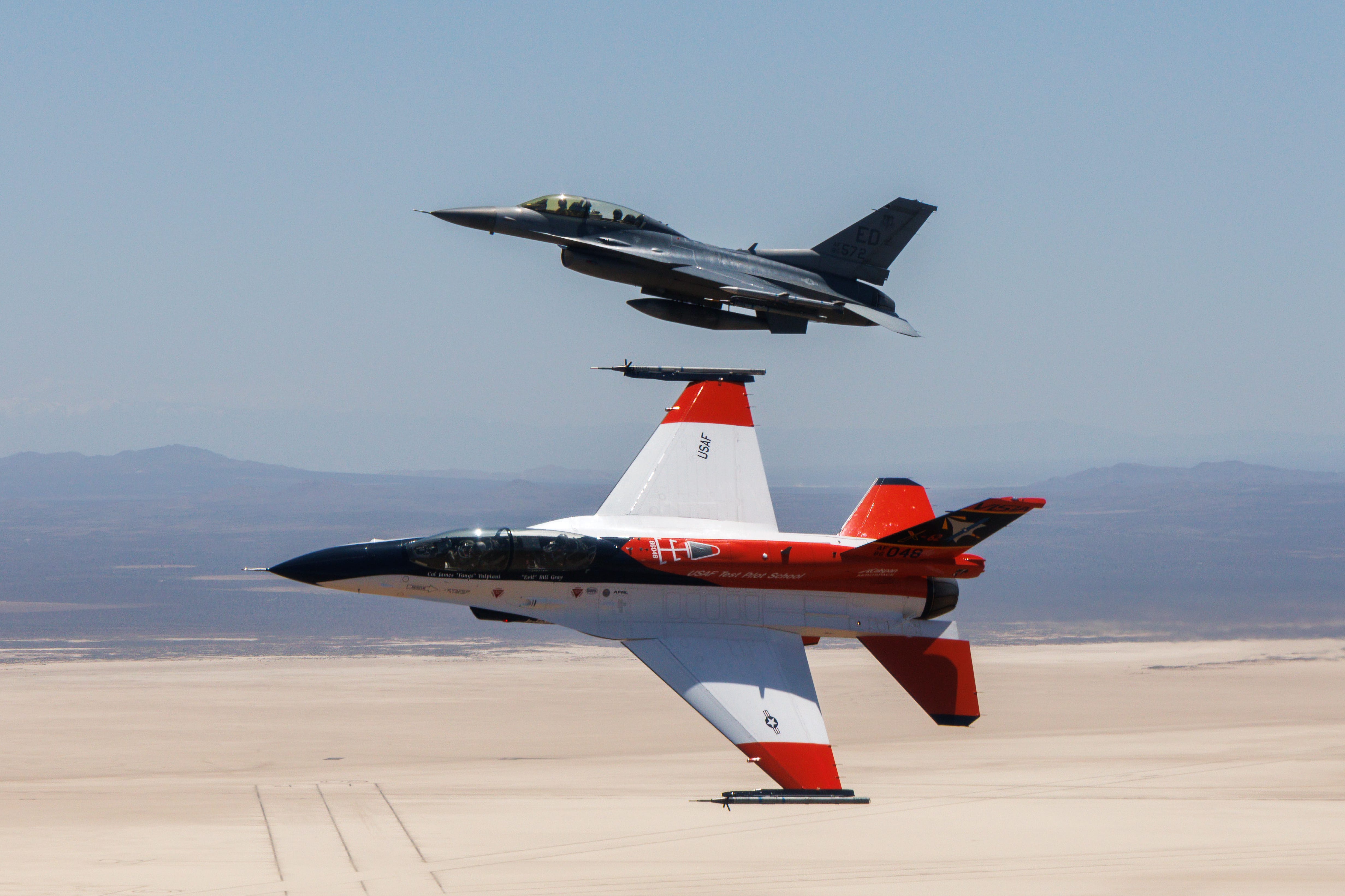 Air Force F-16 flies alongside a modified F-16 piloted by an AI algorithm.