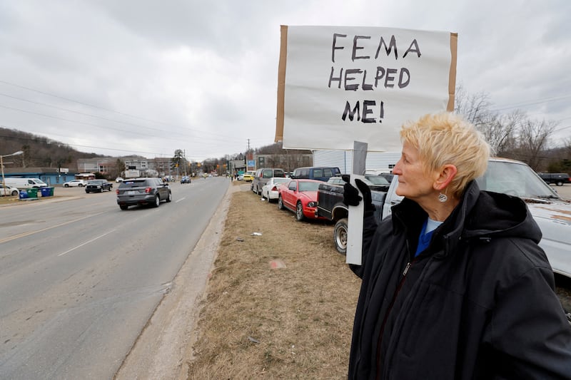 A woman shows support for FEMA after Hurricane Helene hit North Carolina