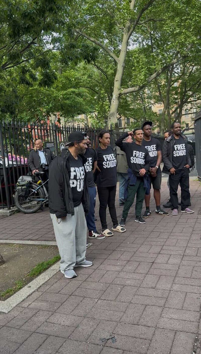 People wearing "Free $Diddy" shirts outside court in New York City