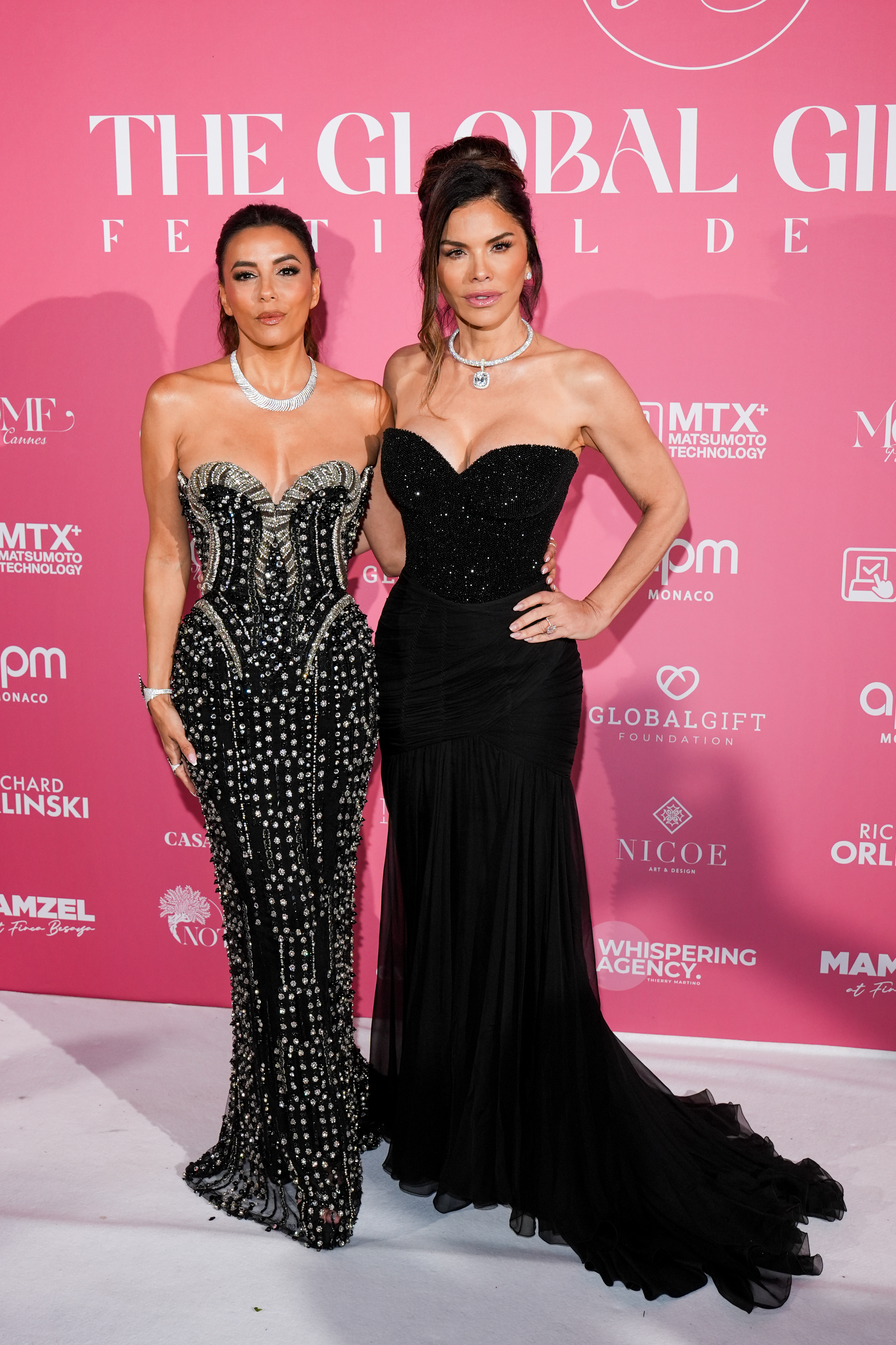 Eva Longoria and Lauren Sánchez on the carpet wearing black. 