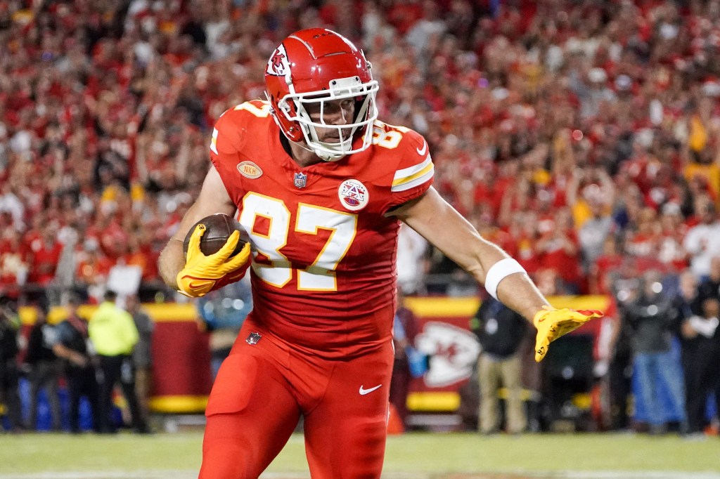 Kansas City Chiefs tight end Travis Kelce (87) runs the ball against the Denver Broncos during the first half at GEHA Field at Arrowhead Stadium. 
