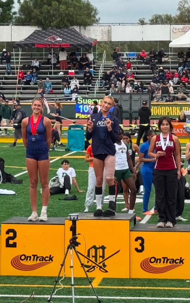 junior trans athlete AB Hernandez of Jurupa Valley -- who won titles in the girls' long jump and triple jump -- posed with competitors to take pictures on the podium.