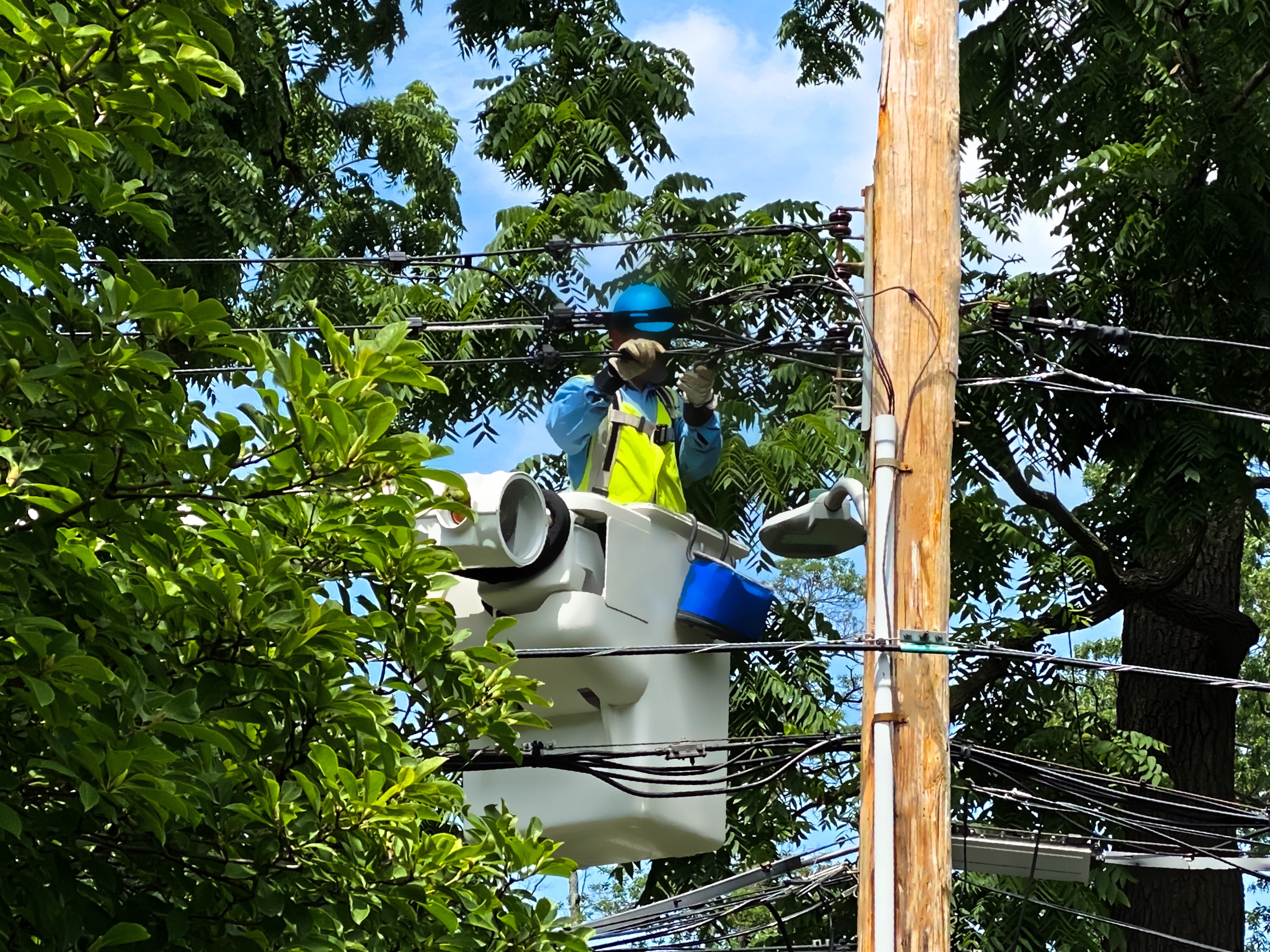A worker repairing power lines